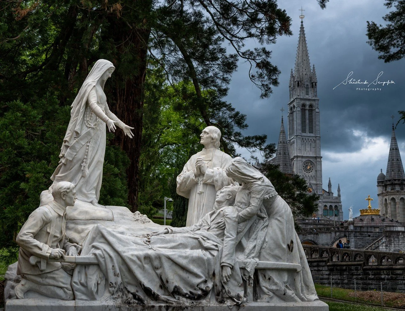 pilgrimage in the city of lourdes france dedicated to Lady Virgin Mary also known as Immaculate Conception who gave apparition to St. Bernadette featuring sanctuary church basilica grotto cave miraculous water and Marian procession