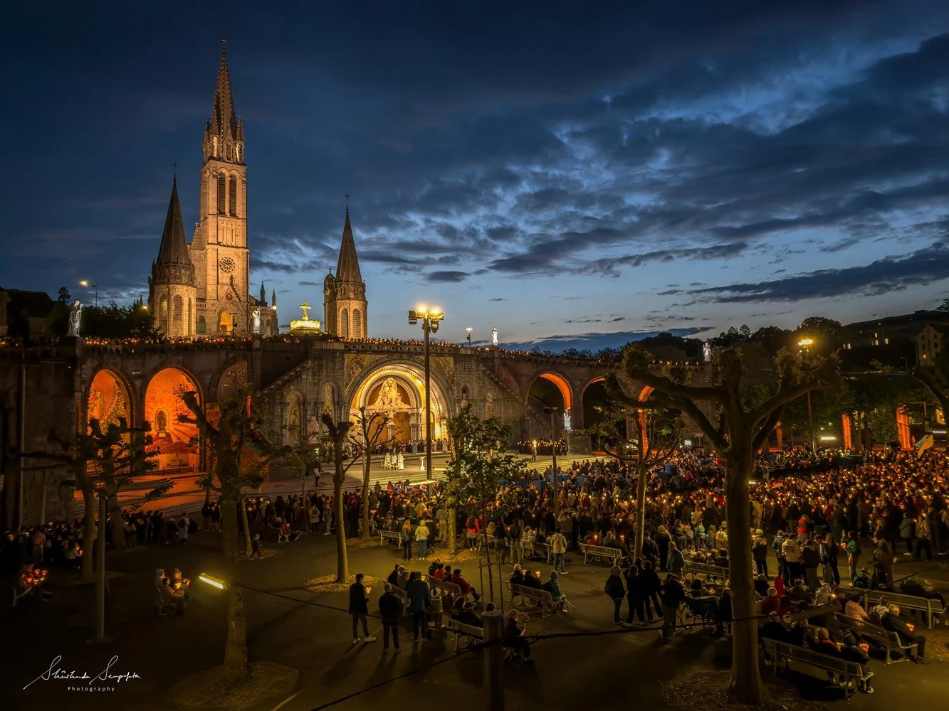 pilgrimage in the city of lourdes france dedicated to Lady Virgin Mary also known as Immaculate Conception who gave apparition to St. Bernadette featuring sanctuary church basilica grotto cave miraculous water and Marian procession