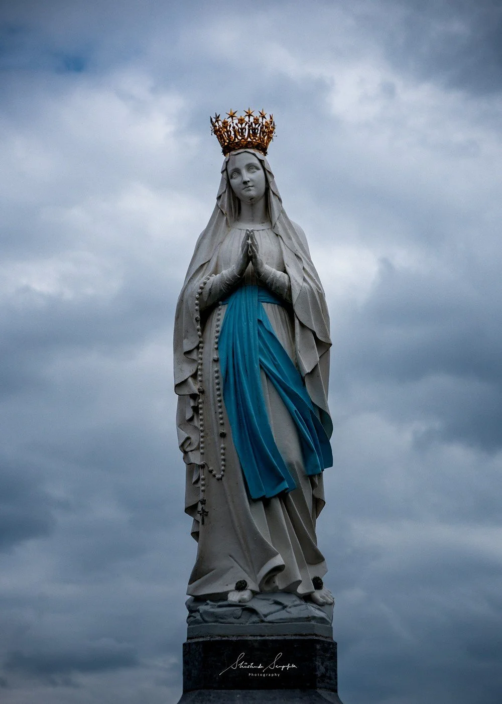 pilgrimage in the city of lourdes france dedicated to Lady Virgin Mary also known as Immaculate Conception who gave apparition to St. Bernadette featuring sanctuary church basilica grotto cave miraculous water and Marian procession