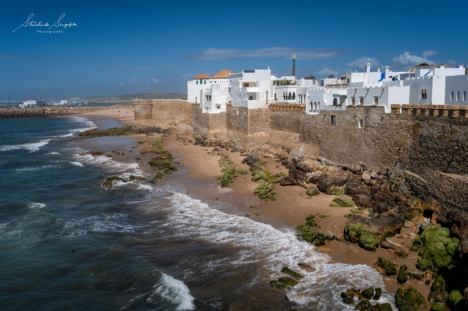 asilah in morocco africa featuring blue medina with painted doors windows street art graffiti mural krikia viewpoint raissouni palace alqamra tower and Grand Mosque