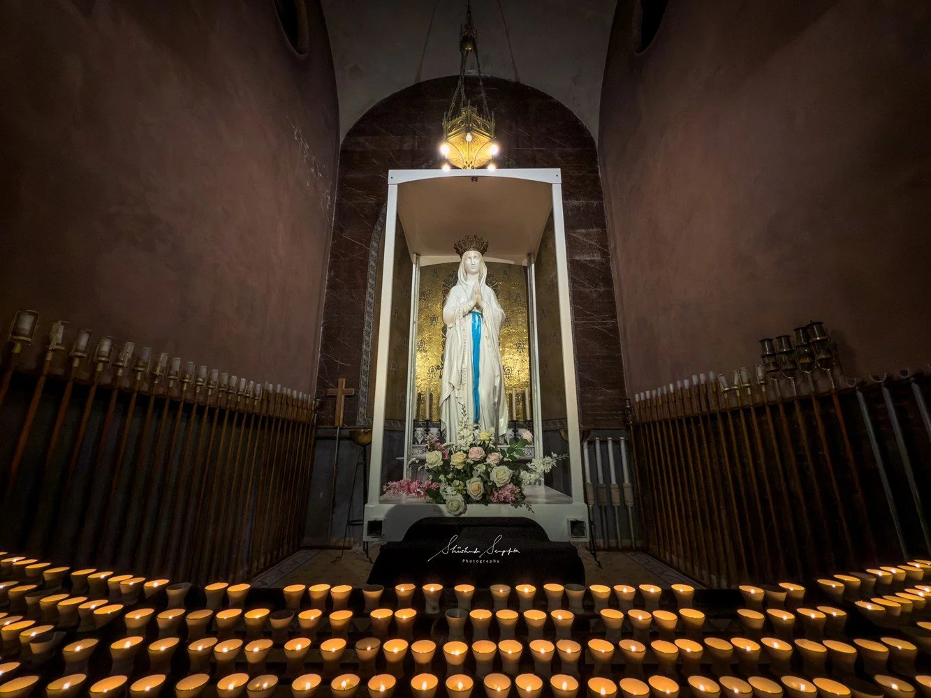 pilgrimage in the city of lourdes france dedicated to Lady Virgin Mary also known as Immaculate Conception who gave apparition to St. Bernadette featuring sanctuary church basilica grotto cave miraculous water and Marian procession