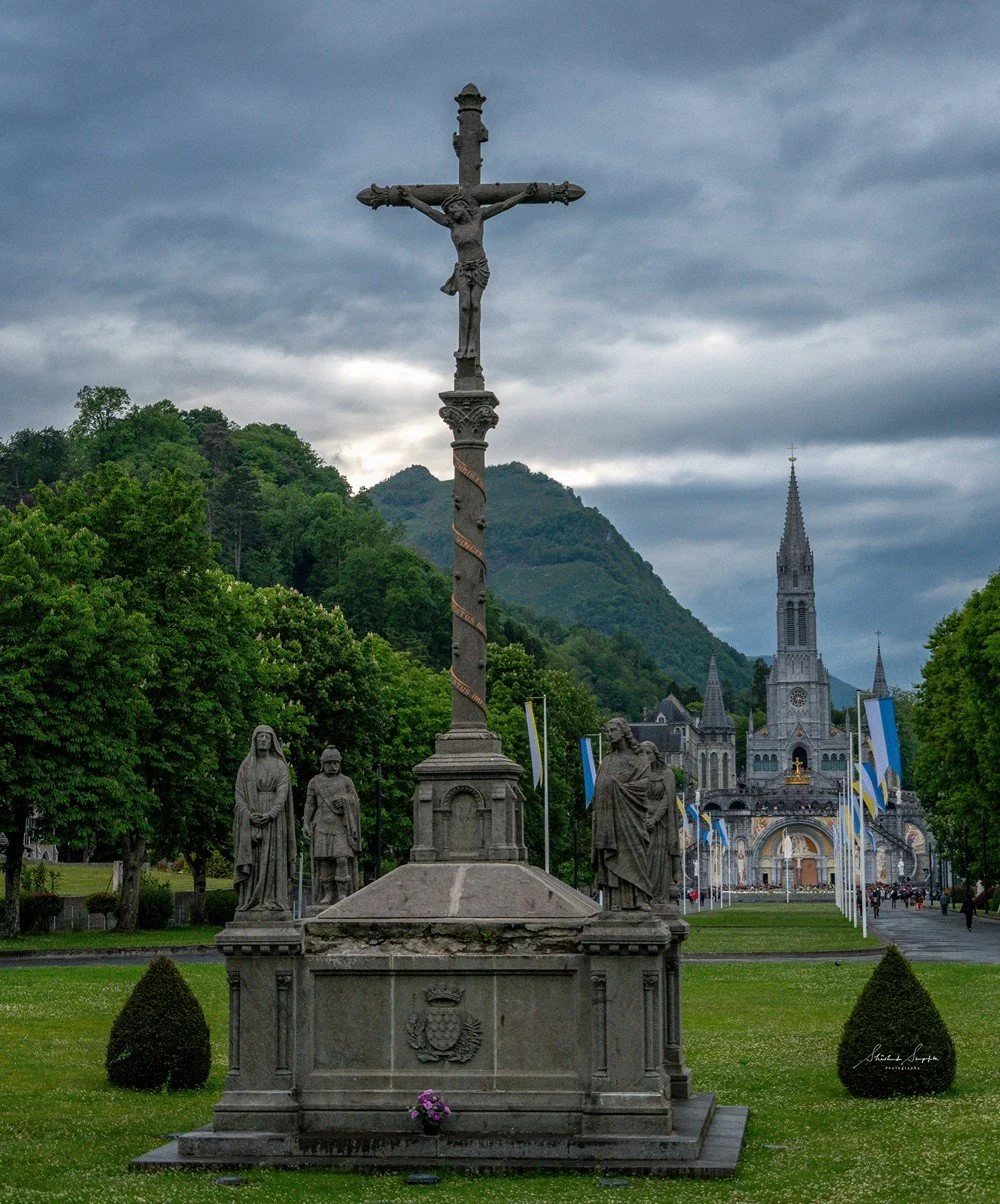 pilgrimage in the city of lourdes france dedicated to Lady Virgin Mary also known as Immaculate Conception who gave apparition to St. Bernadette featuring sanctuary church basilica grotto cave miraculous water and Marian procession