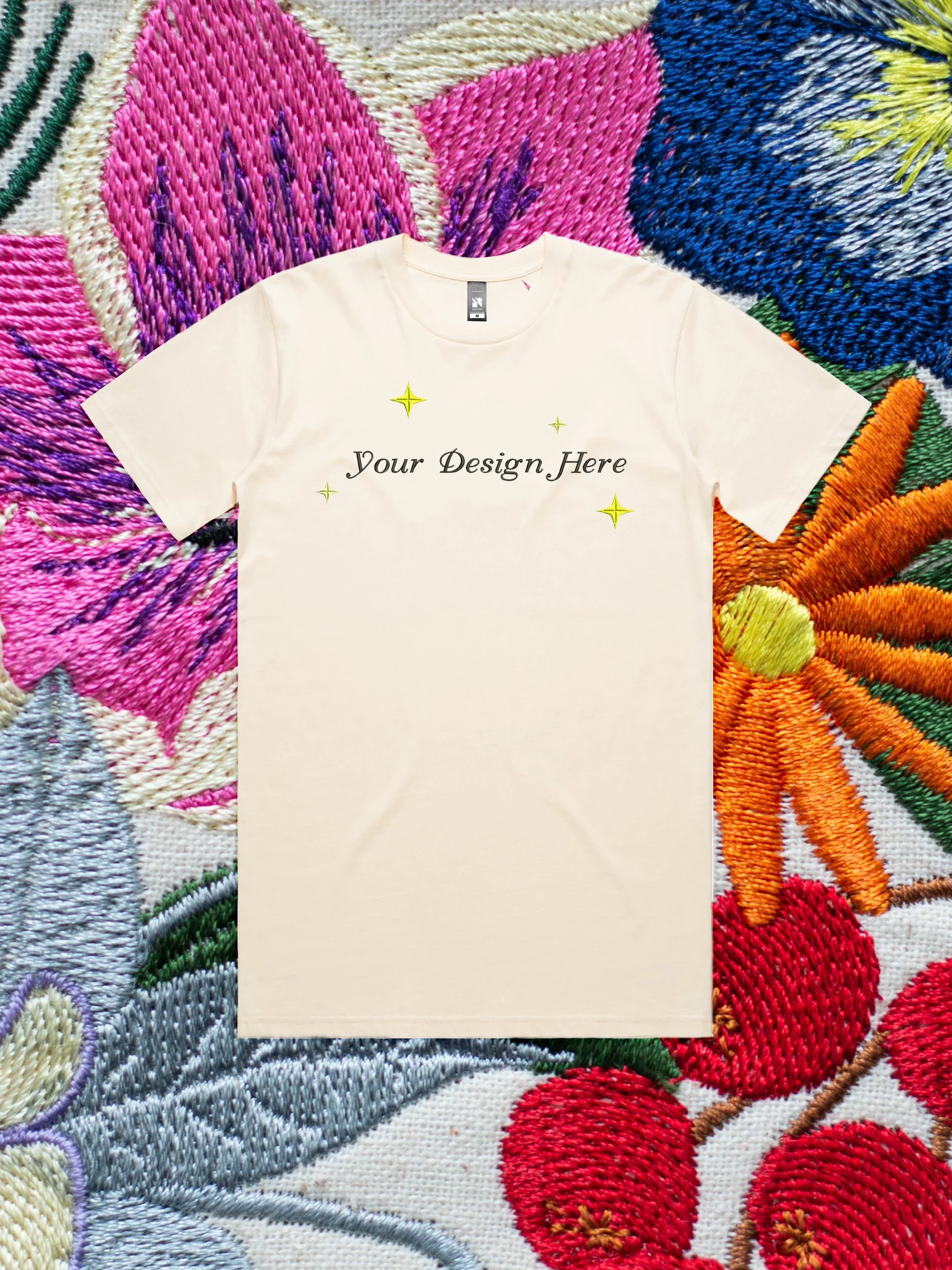 Custom Embroidery on a t-shirt against an embroidered floral background.