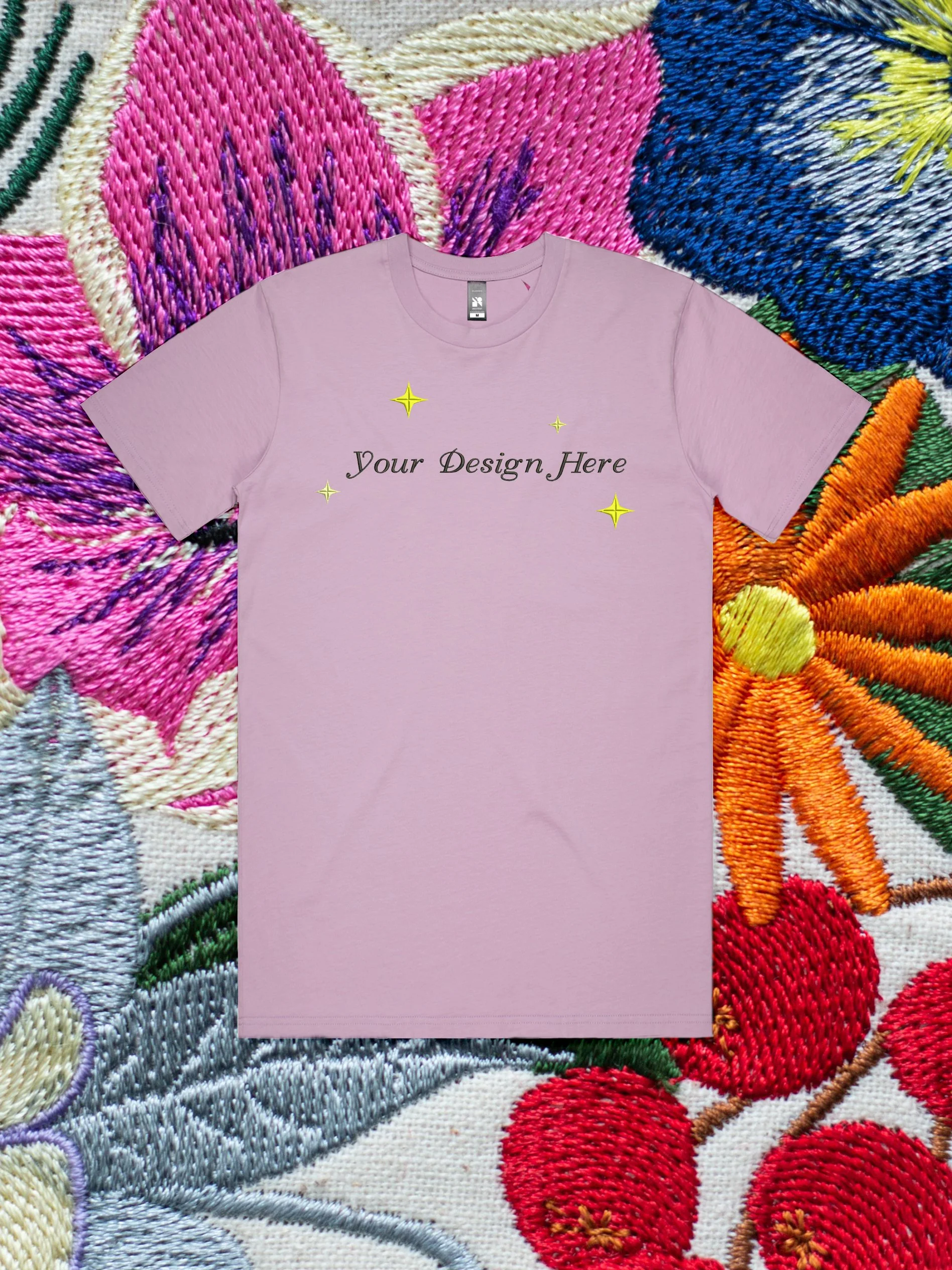 Custom Embroidery on a t-shirt against an embroidered floral background.