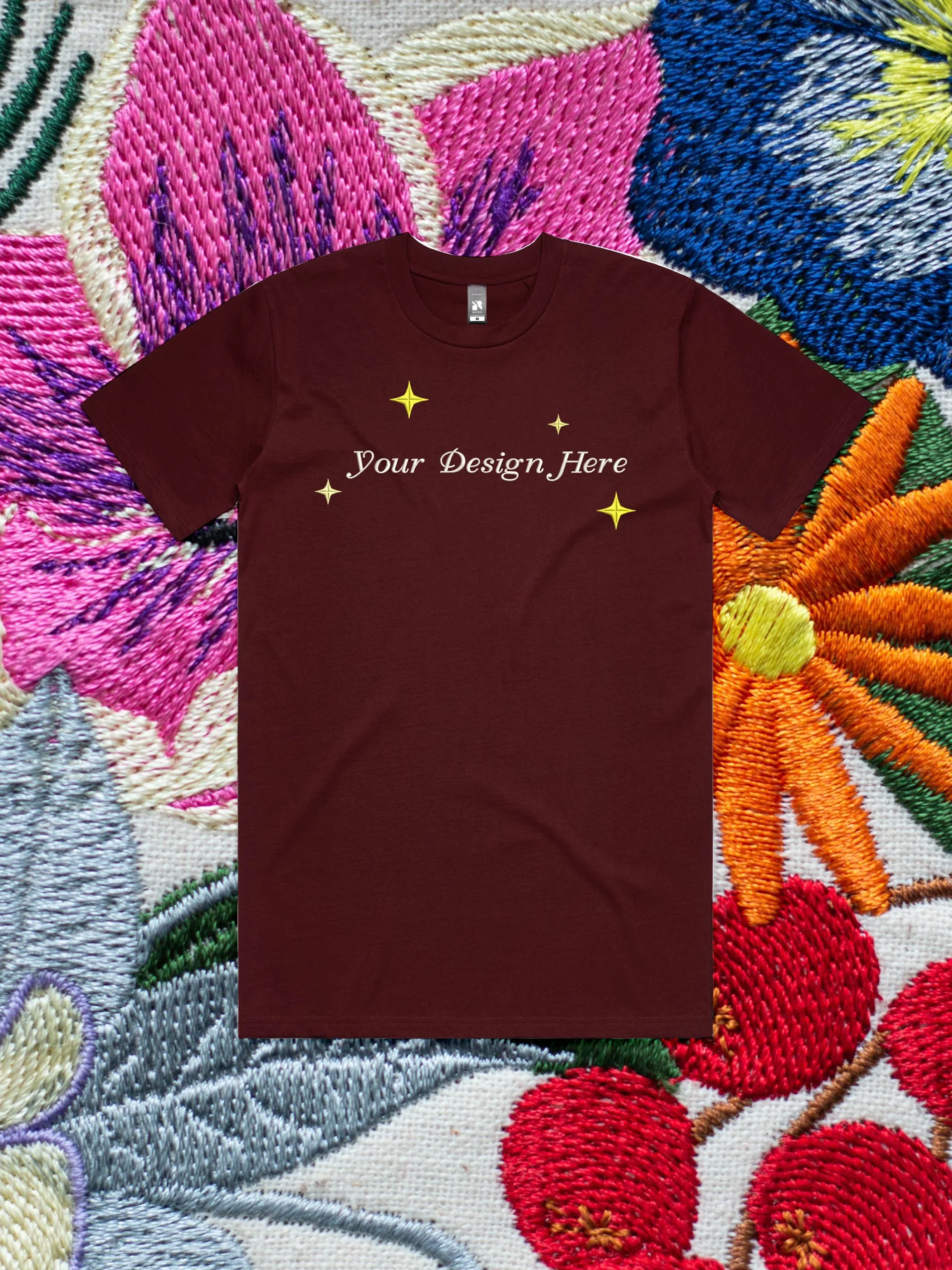 Custom Embroidery on a t-shirt against an embroidered floral background.