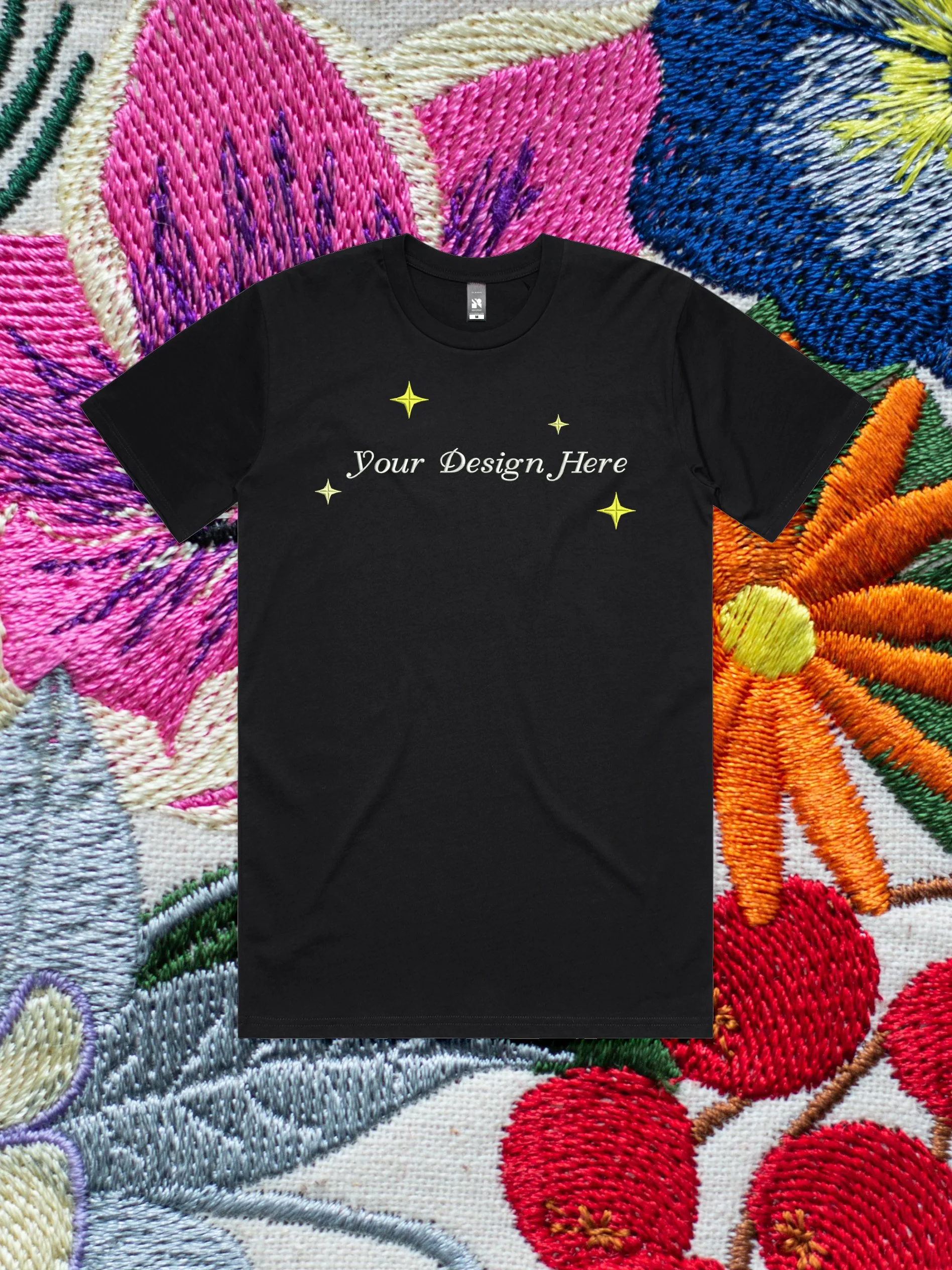 Custom Embroidery on a t-shirt against an embroidered floral background.