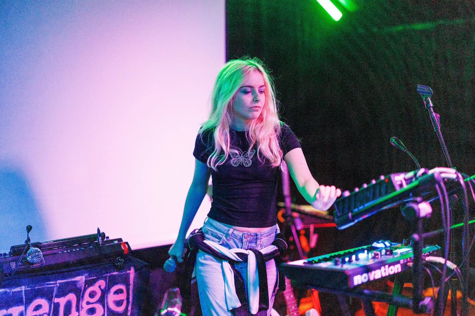Picture of artist Emzae performing on stage solo with 2 keyboards