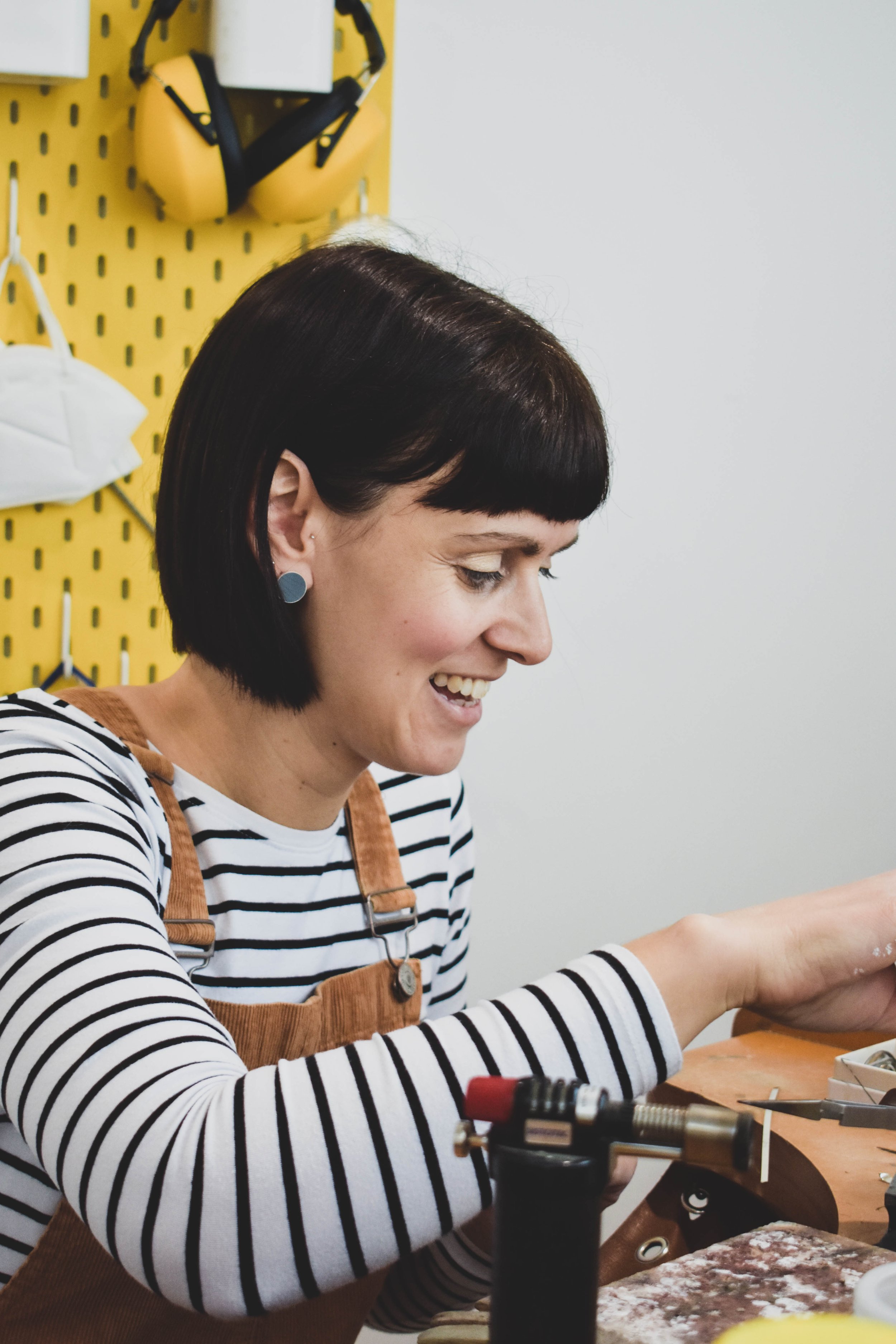 Contemporary jeweller Claire Lowe working at her jewellery bench