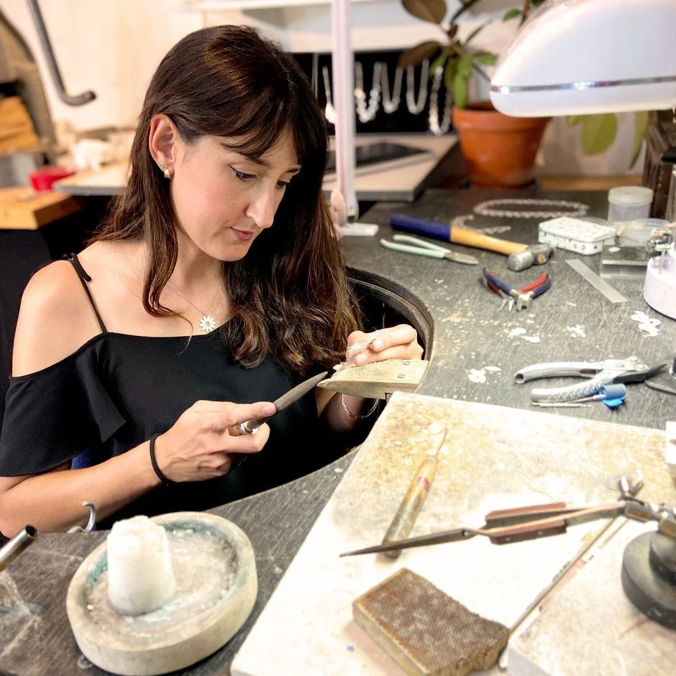 Jeweller Cara Tonkin handcrafting jewellery at her workbench