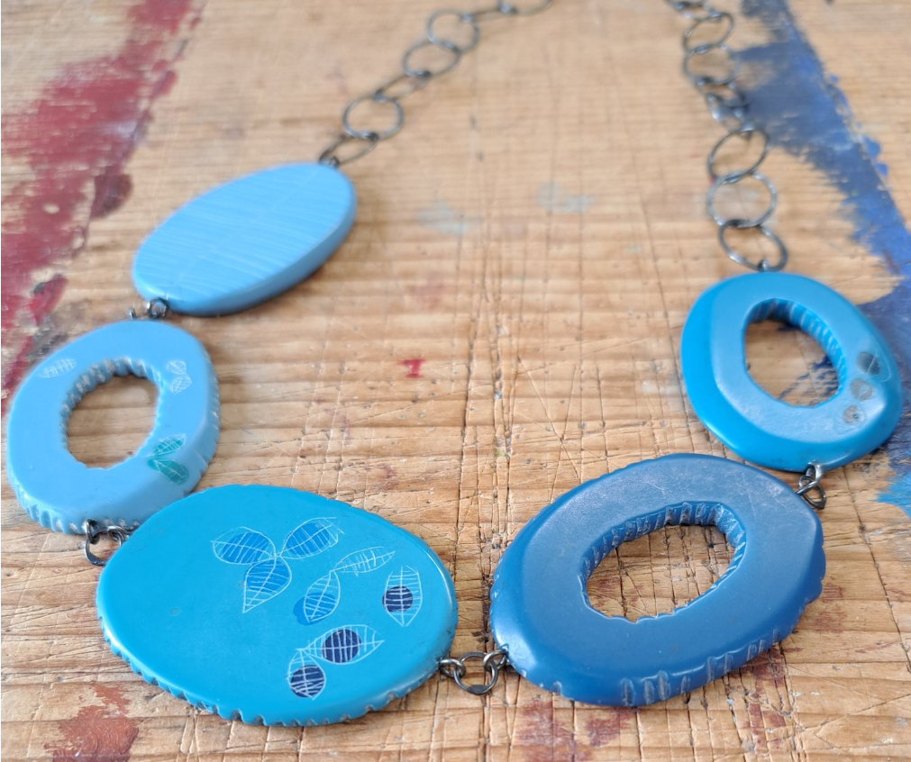 Blue resin statement necklace handmade by contemporary jeweller Carla Edwards