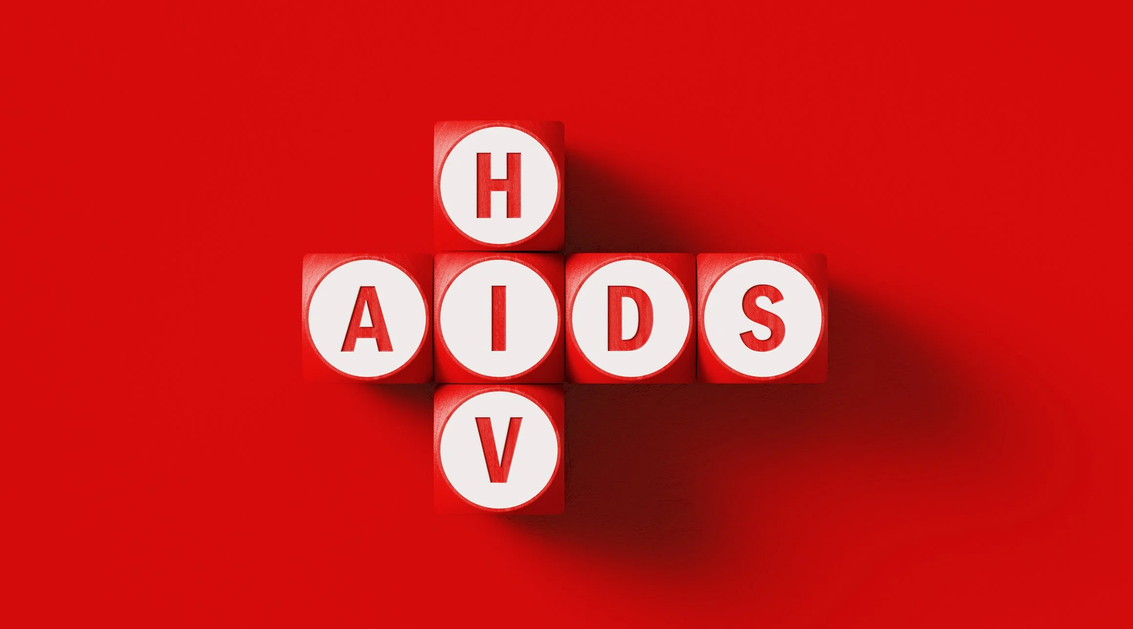Blocks spelling out 'HIV/AIDS' on a red background.