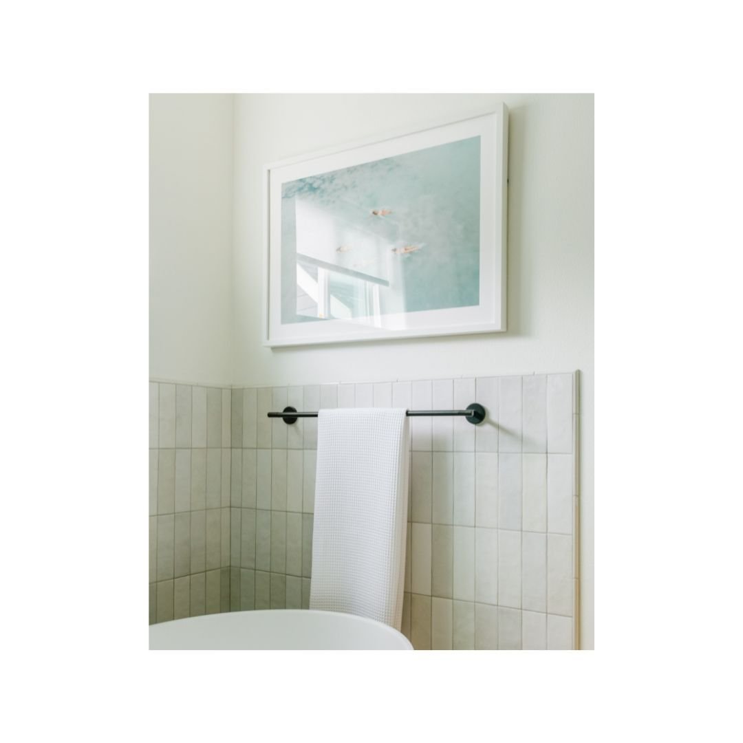 Want to create visual interest without going crazy with color and pattern? Try laying tiles in a unique format and explore neutral tiles that offer variable hues. We opted for a vertical straight stack of a Zellige style subway tile in this serene pr