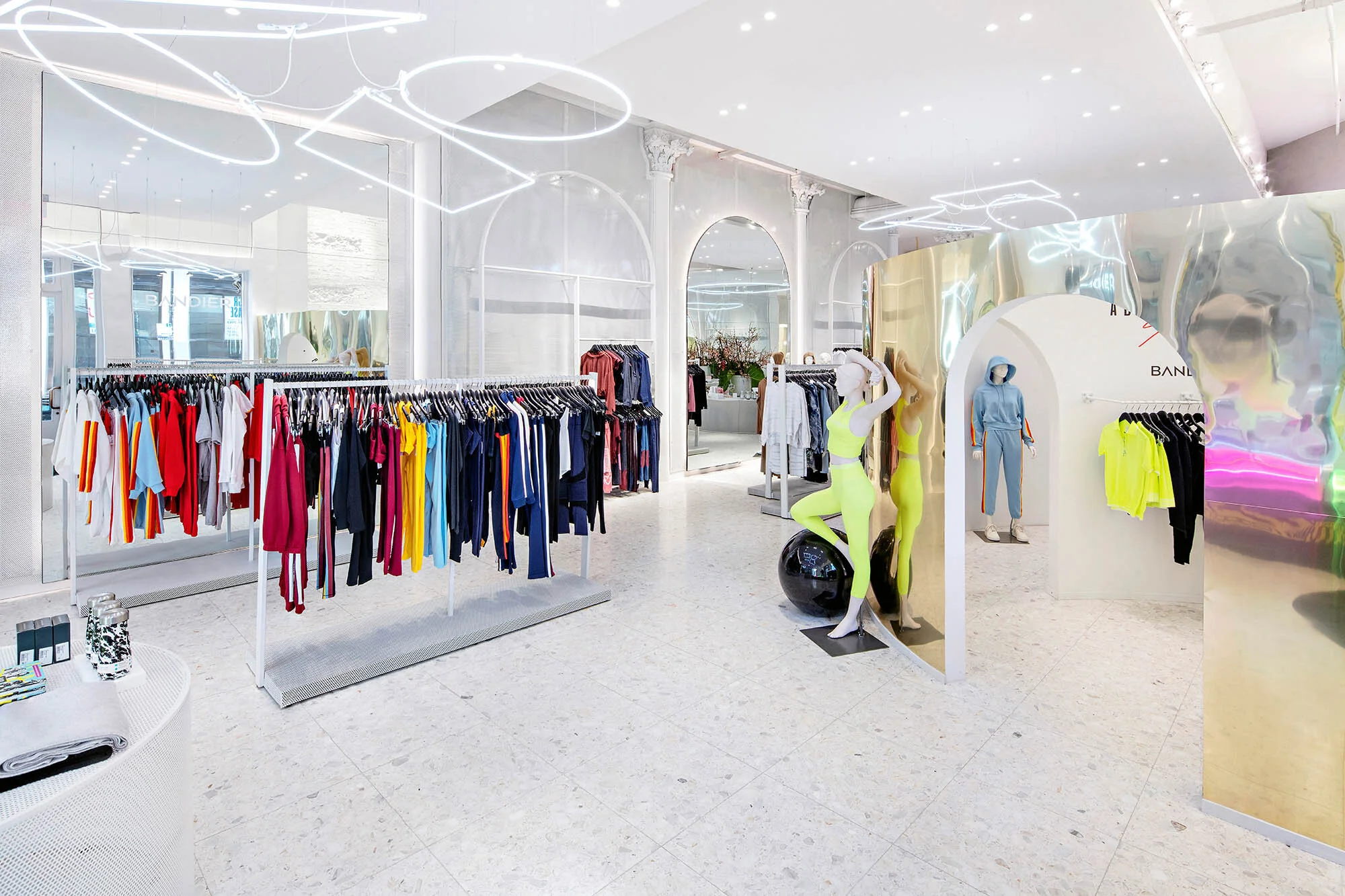 Bandier Clothing Racks and circular chromed divider wall