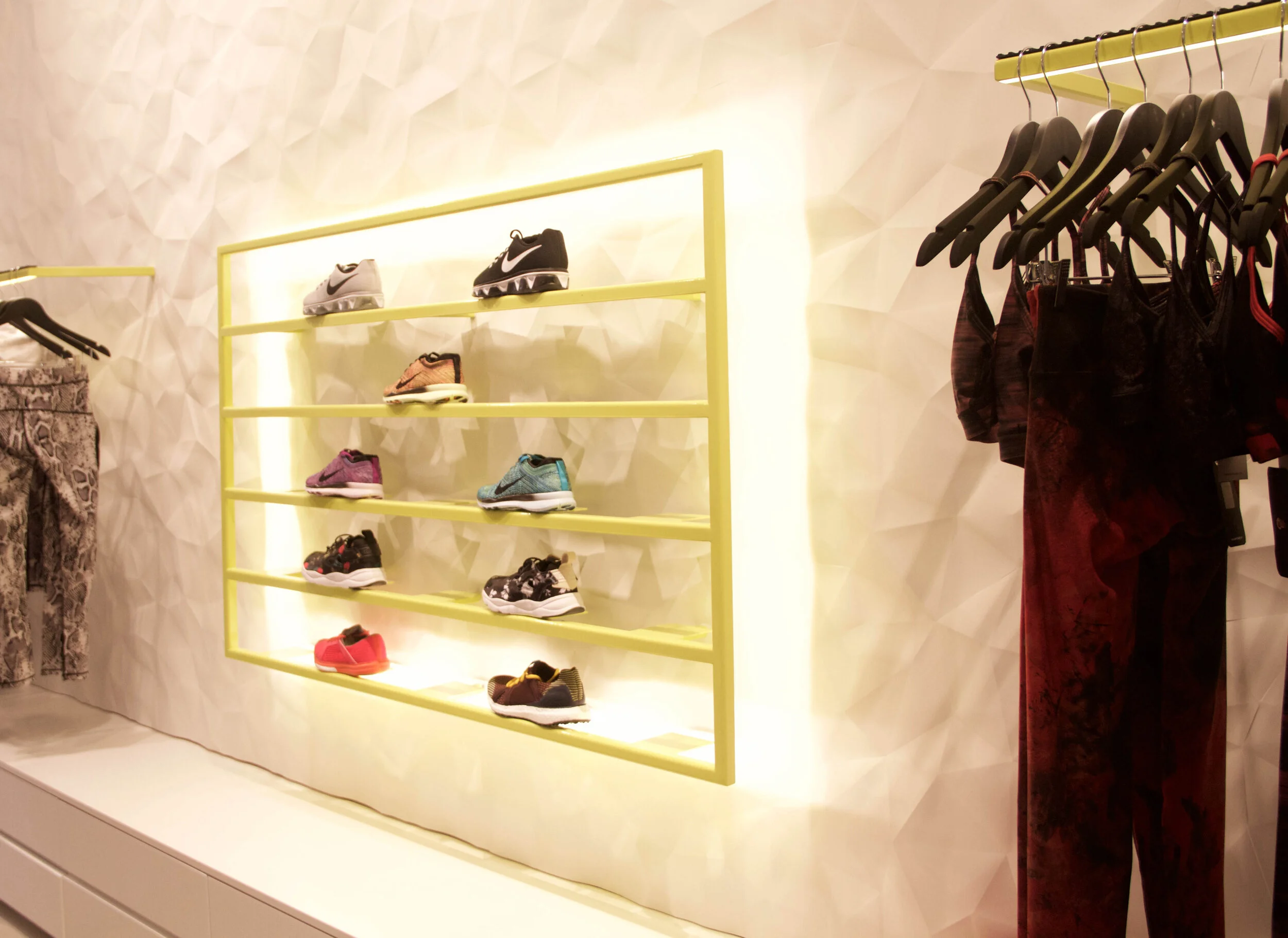 Backlit, metal shoe rack with unique wall texturing