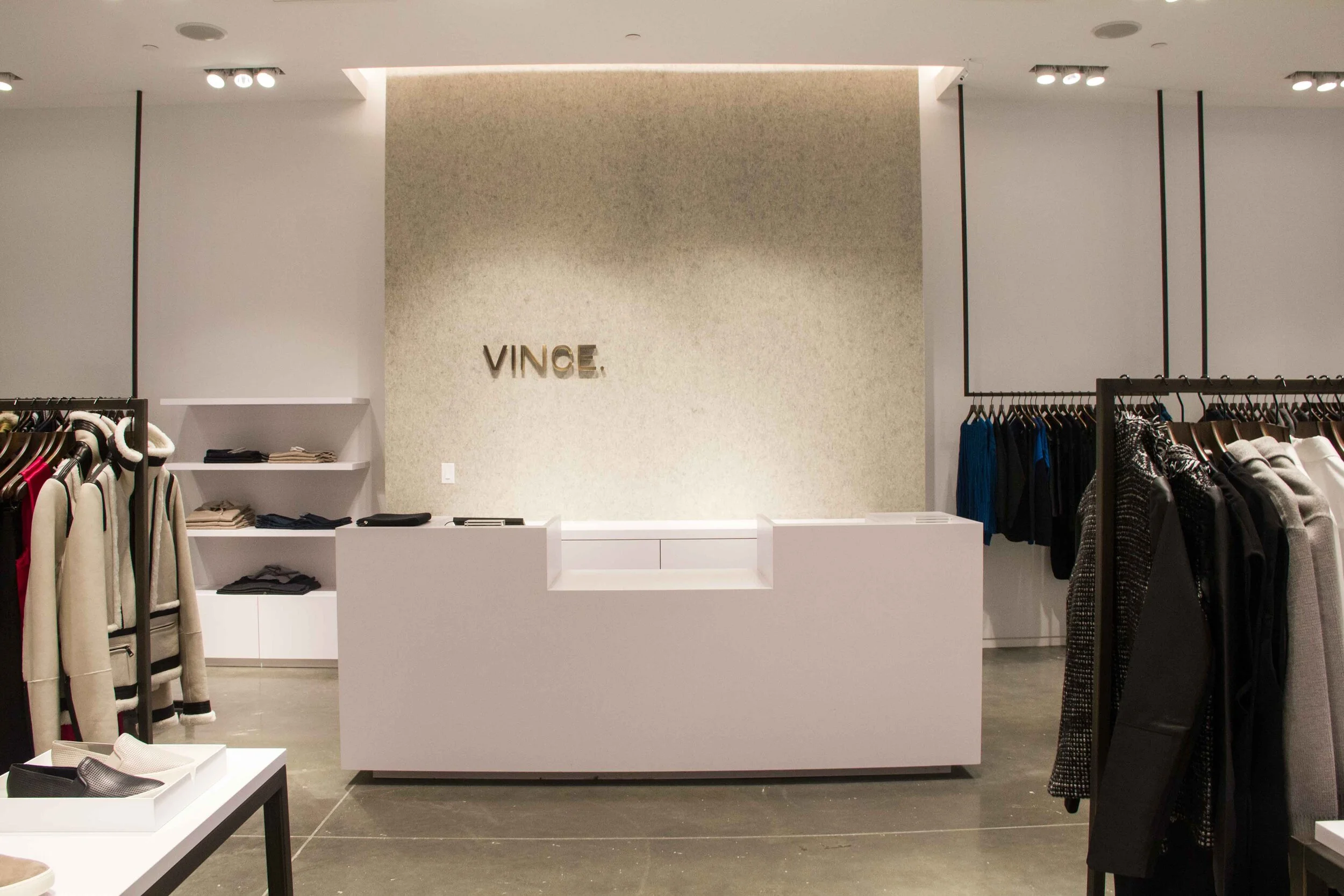 Vince logo wall and cashier desk