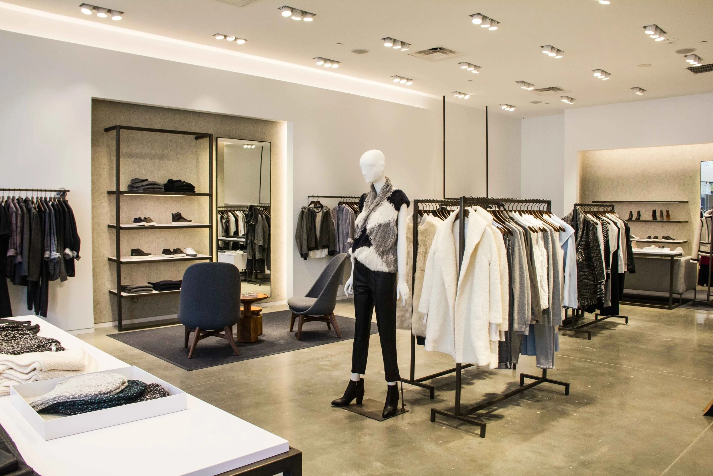 Retail interior with clothing racks and table displays