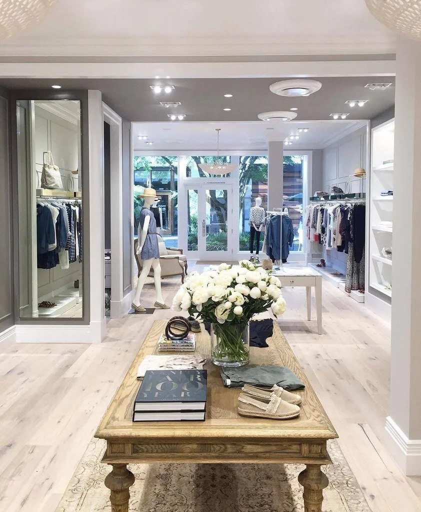 Well lit women's retail space with clothing and accessories.