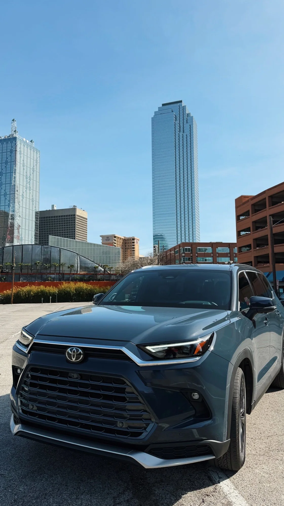 Toyota Grand Highlander with the downtown Dallas skyline behind it