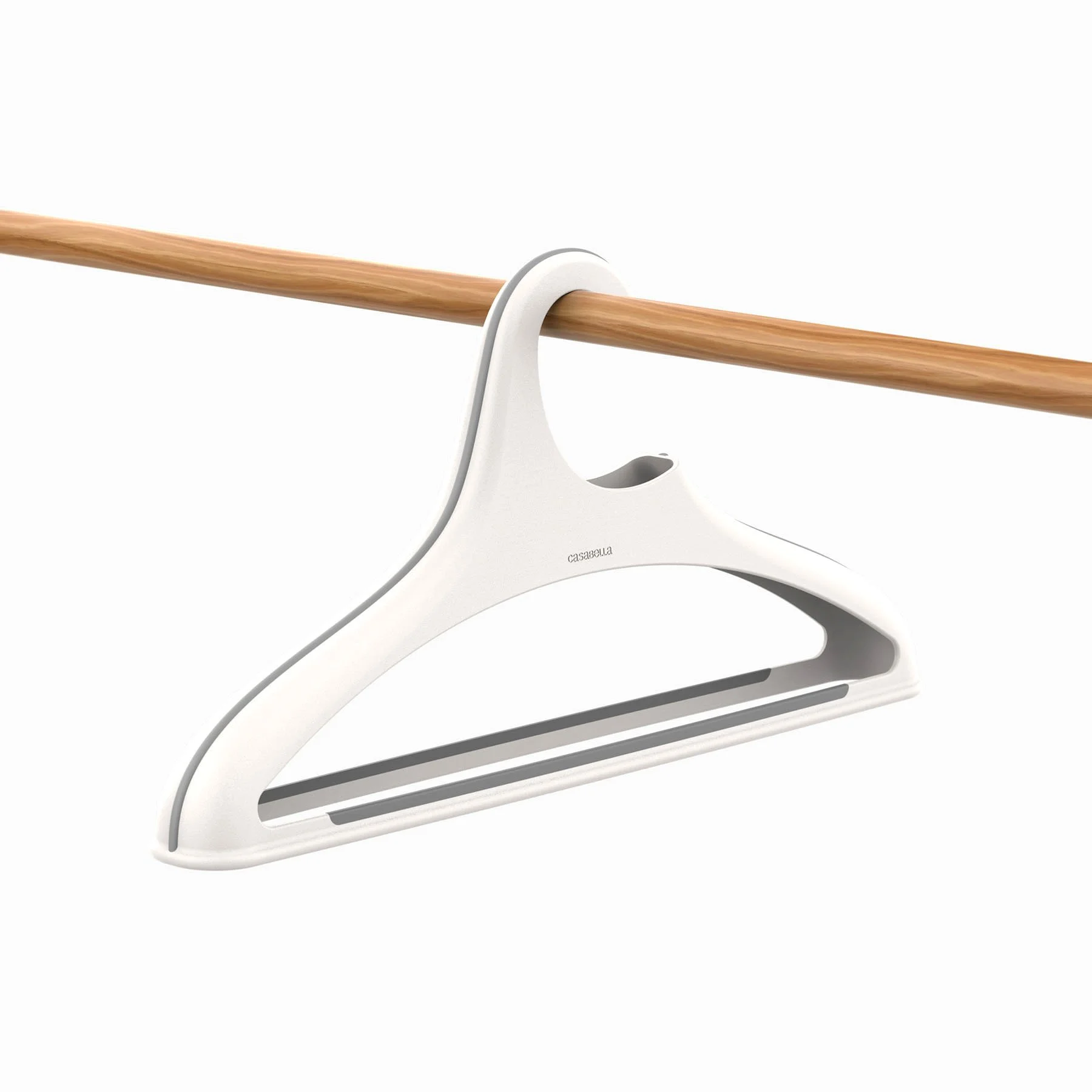 Casabella Nest Hanger displayed on a wooden closet rod, showing the wider shoulder profile designed to maintain the shape of coats and structured clothing