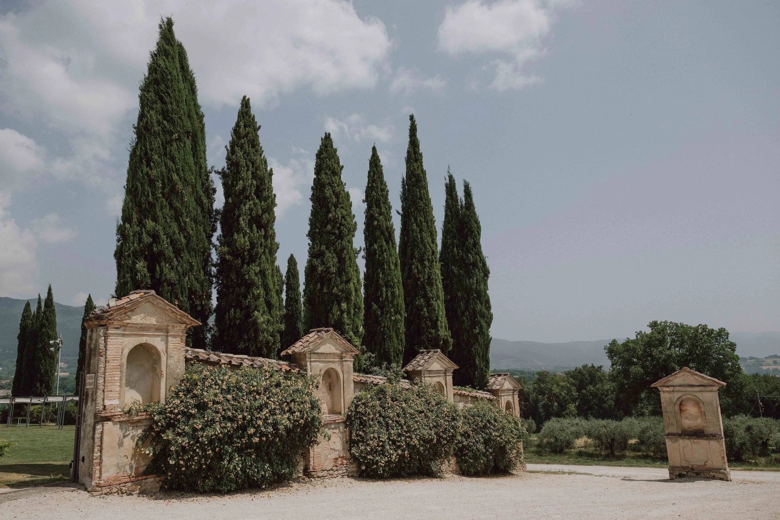 Cypresses and old ruins at San Pietro sopra le Acque.jpg