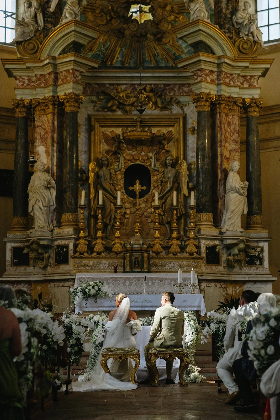 Couple exchanging vows at the altar inside the Tempio di Santa Maria della Consolazione, a Renaissance church near Todi, Umbria.
