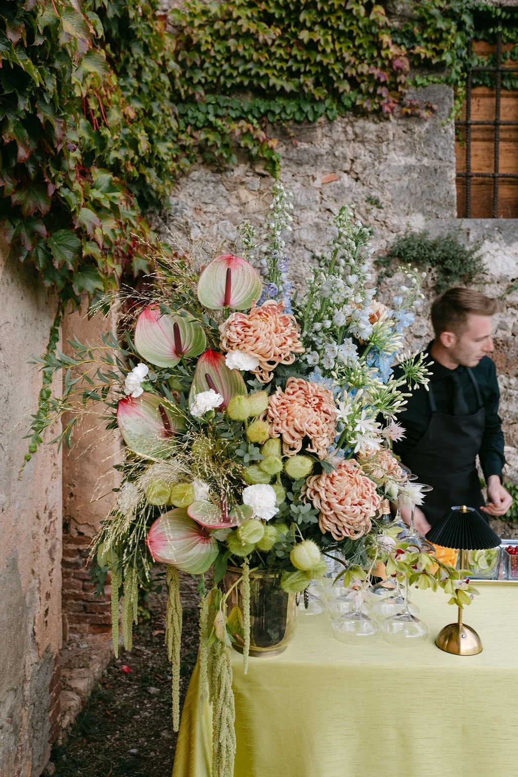 Pink, green and white bar florals at Tuscan wedding