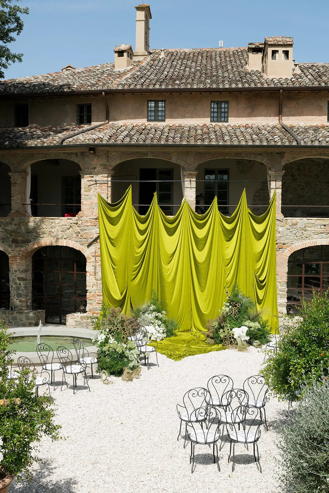 Intimate wedding ceremony, chartreuse drapery, sculptural ikebana florals