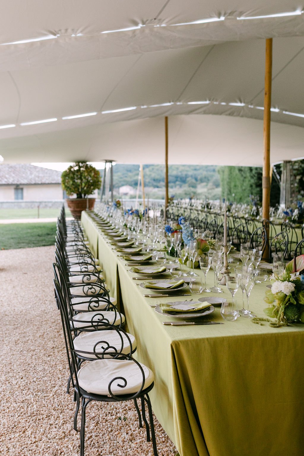 Green linens and colourful florals styling for wedding in gazebo at Castello di Celsa