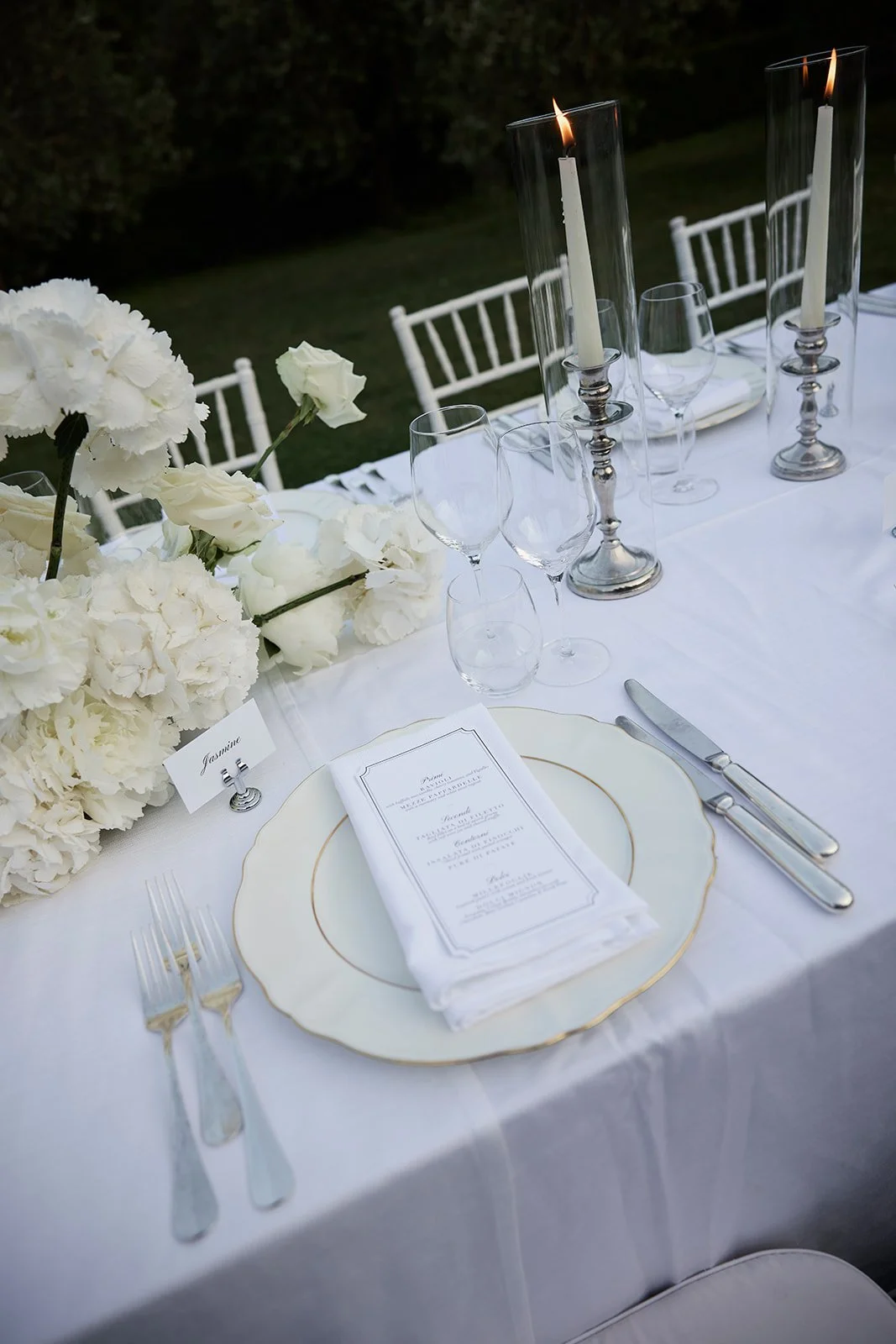 Silver candles and white florals for Tuscan wedding