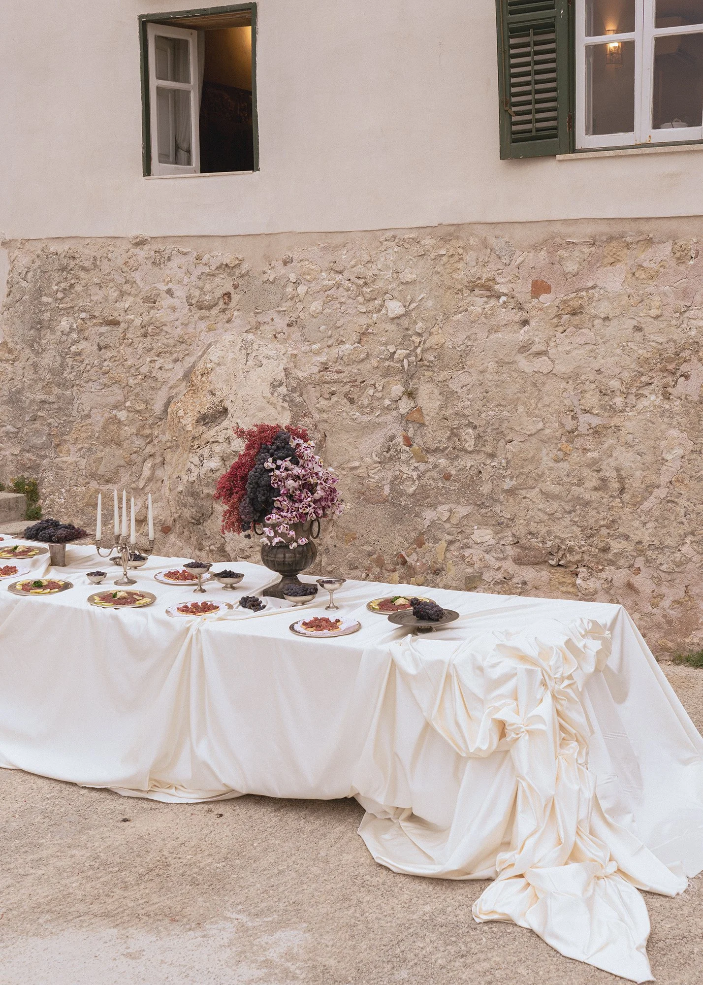 Pink and white florals and candelabras at aperitif at Tonnara di Scopello