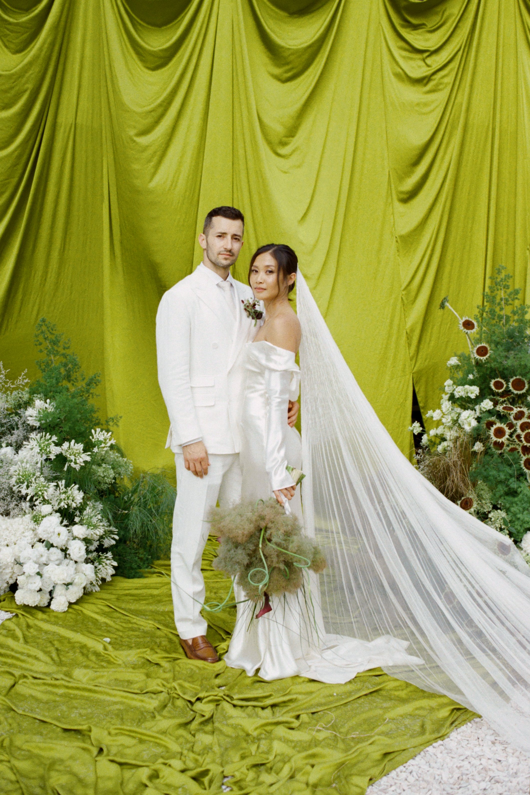Wedding ceremony with green chartreuse drapery and sculptural ikebana florals at Vocabolo Moscatelli in Italy, Umbria