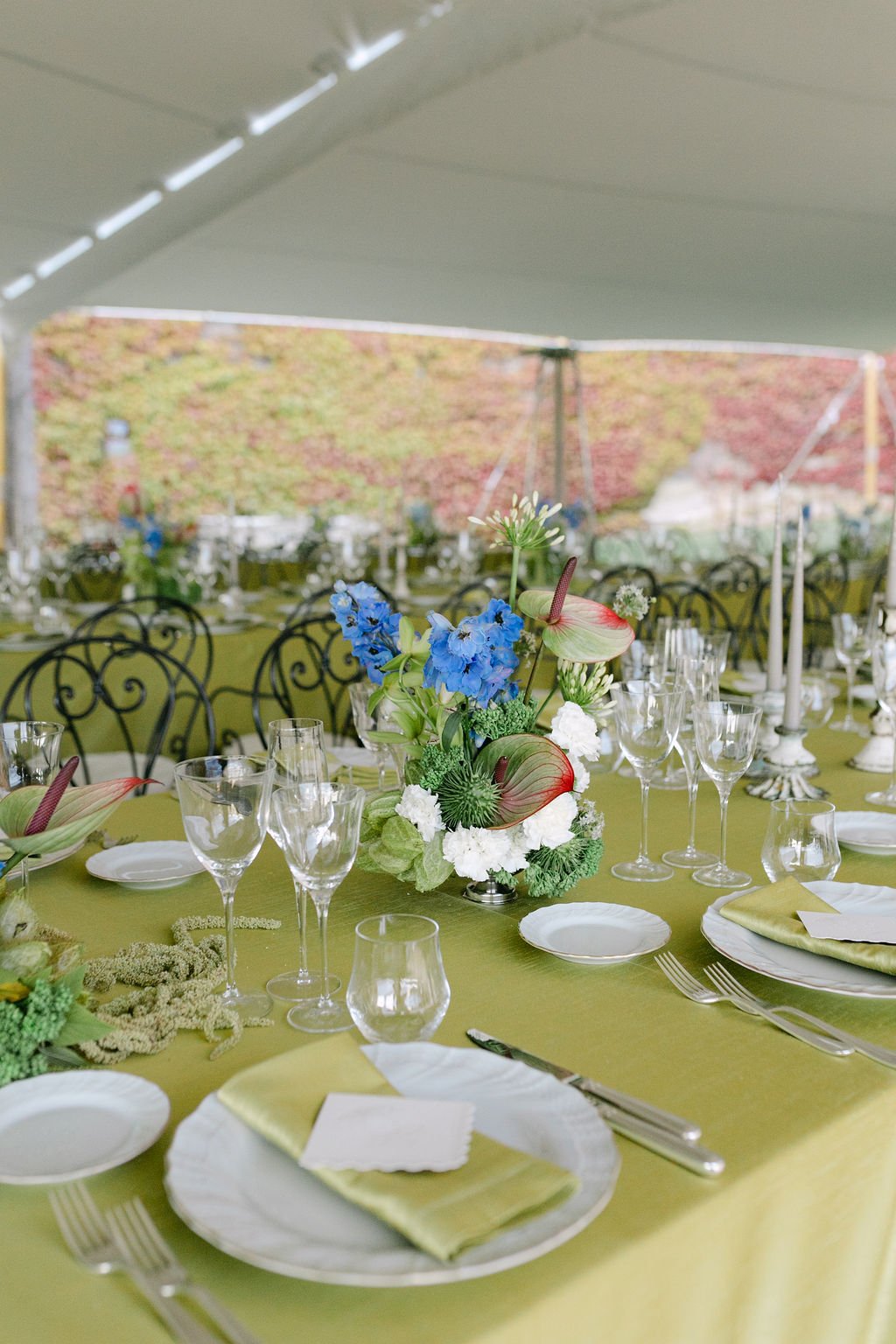 Green linens and colourful florals styling for wedding in gazebo at Castello di Celsa