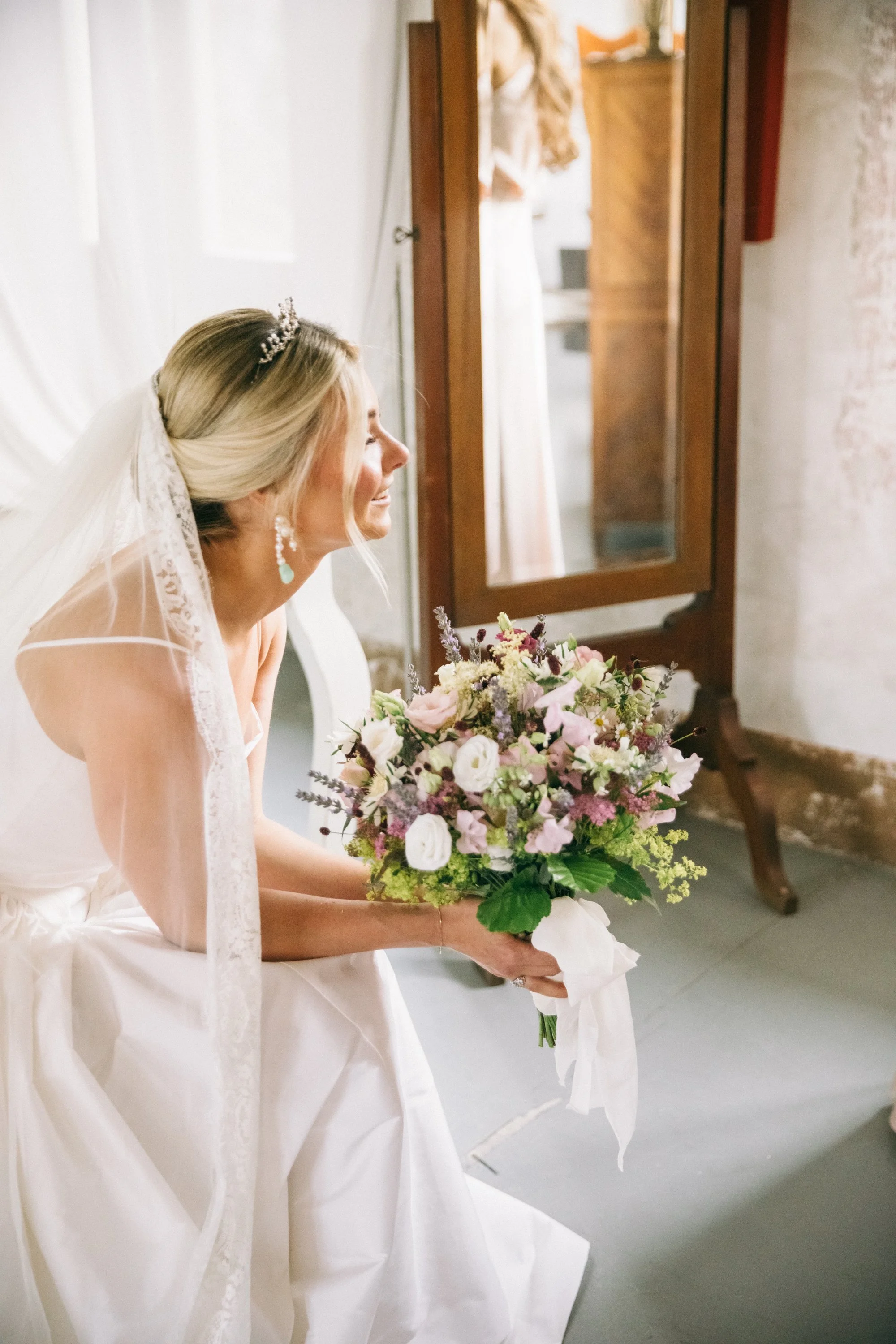 Bridal bouquet made of seasonal green, white and pastel coloured florals