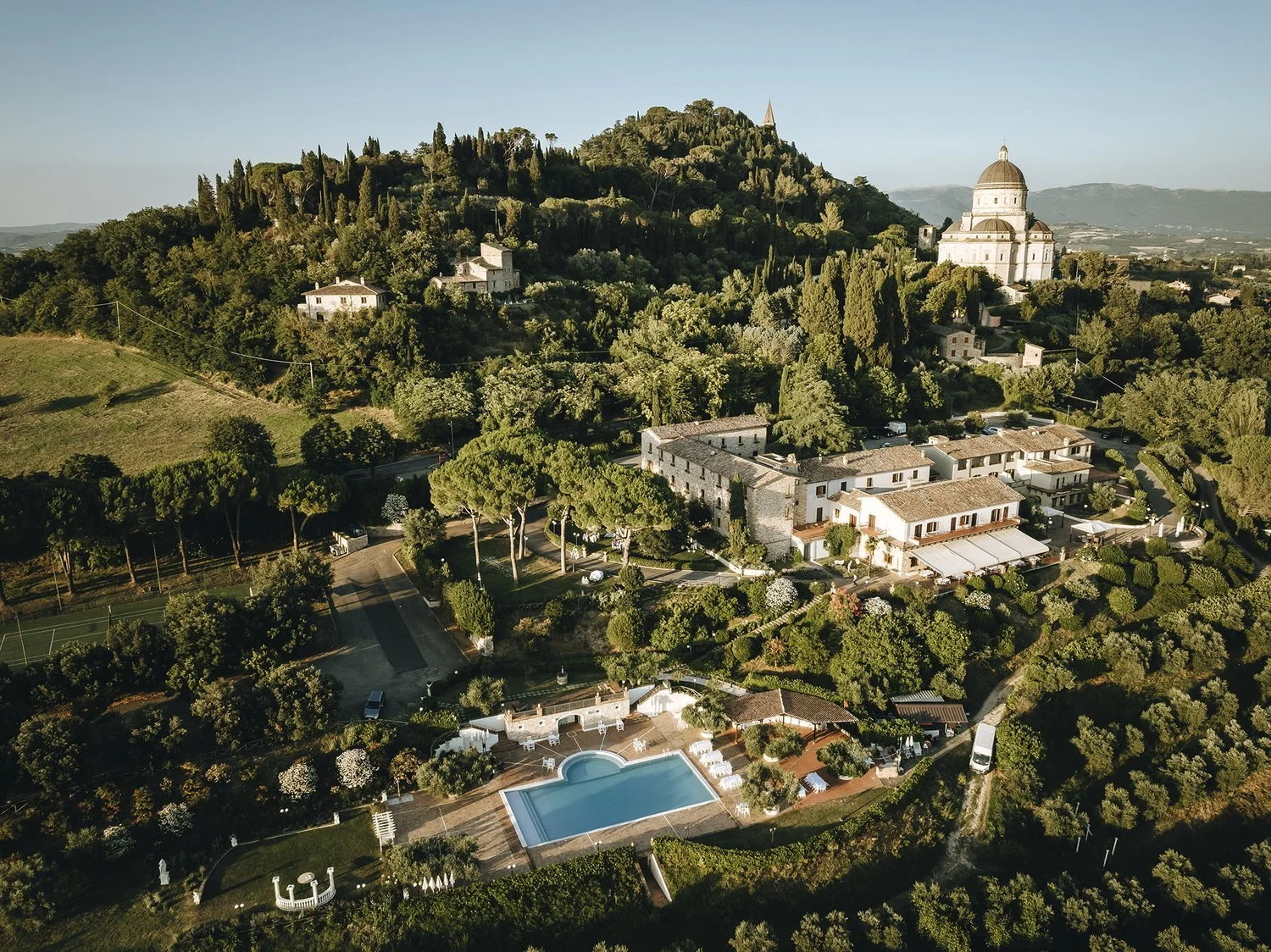 Aerial view of Monastero Santa Margherita, a 12th-century family-run wedding venue in Umbria, Italy, with on-site accommodation and event spaces.