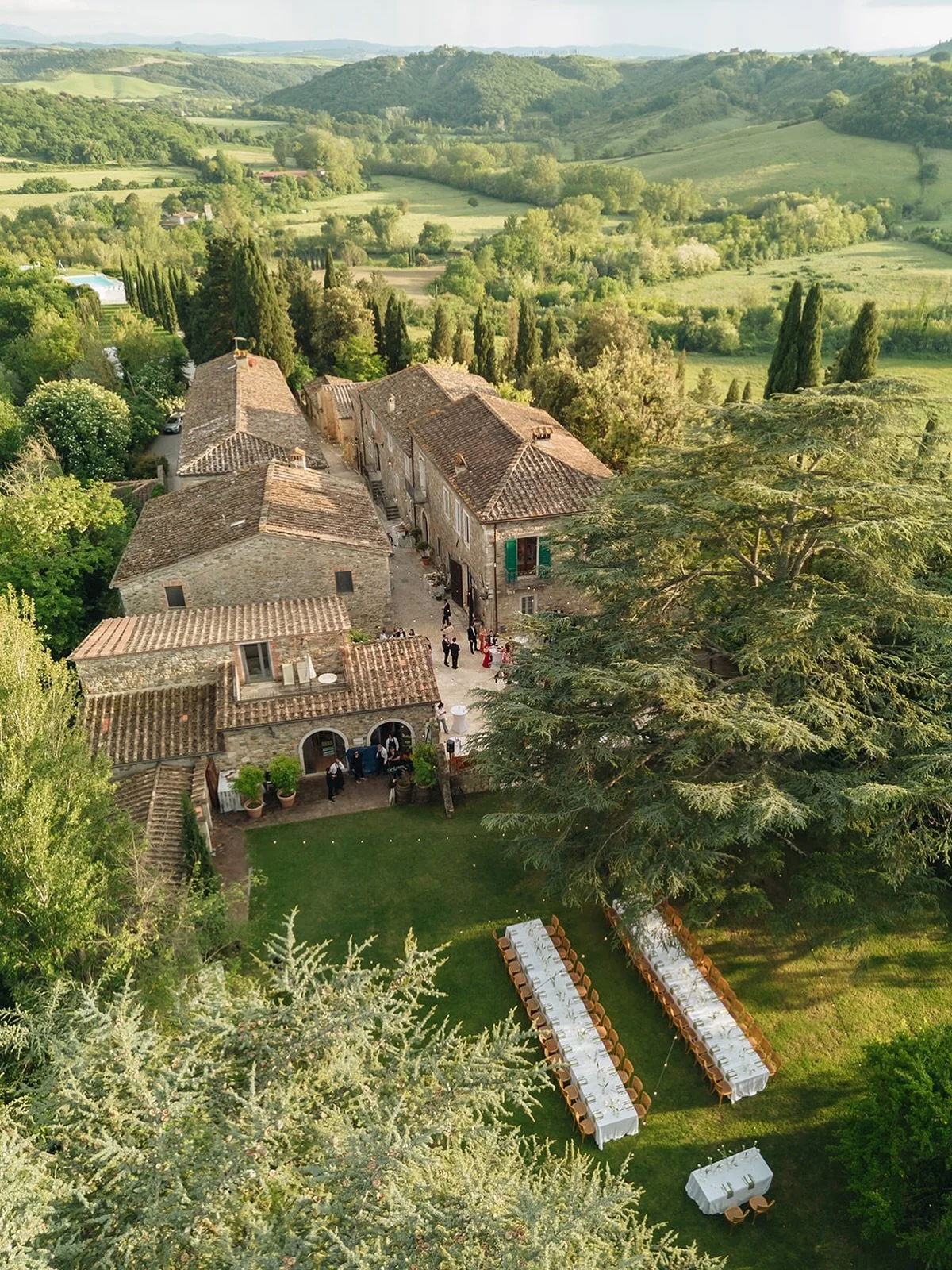 Borgo Laticastelli, a restored medieval hilltop hamlet and wedding venue sleeping up to 80 guests on-site, above the Crete Senesi in Tuscany.