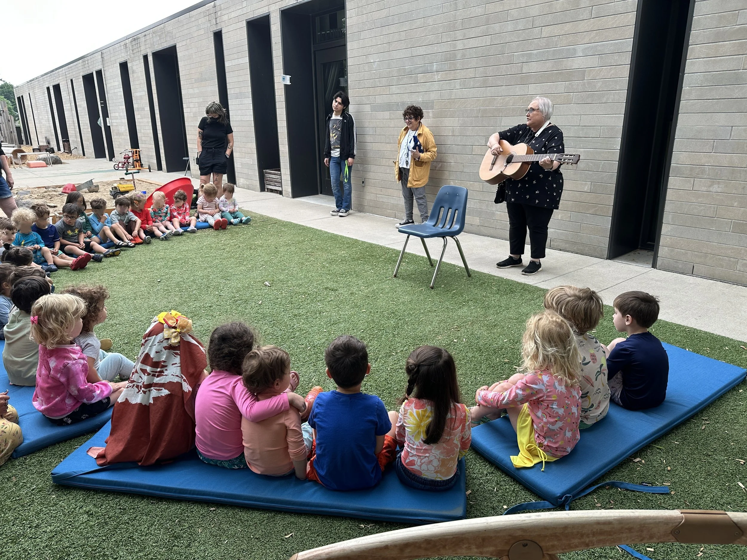 ECC tots listen to music in the playground