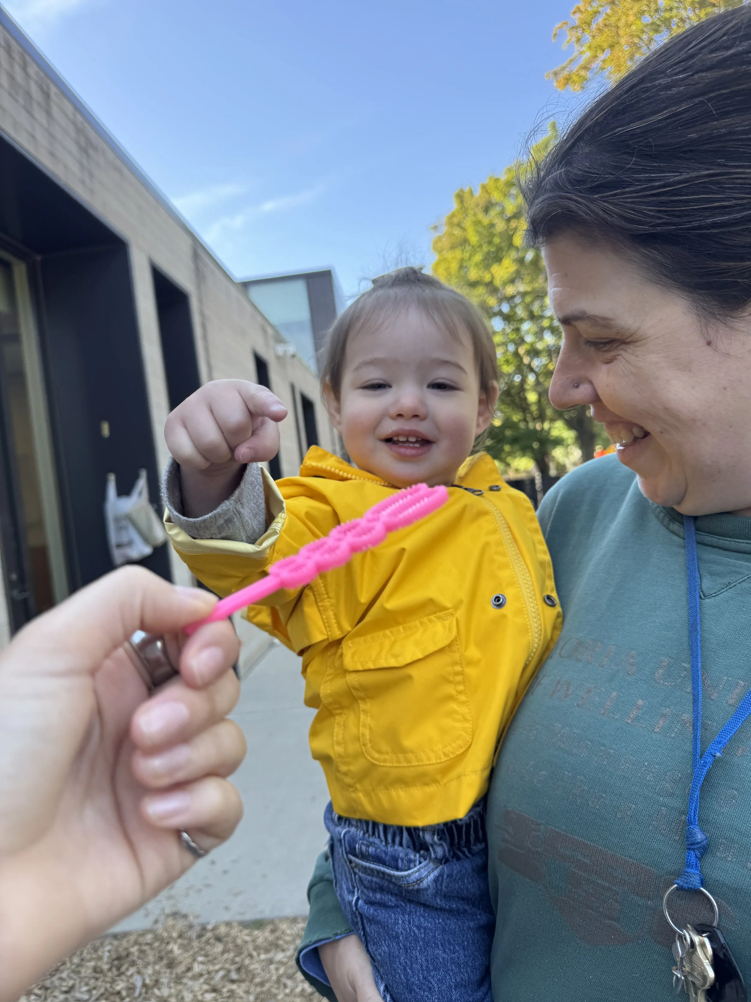 ECC toddler points at bubbles.