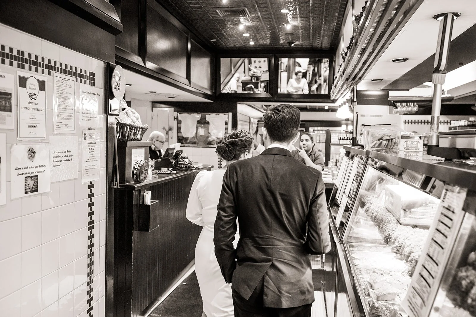 The bride and groom enter the 2nd Avenue Deli in NYC after their City Hall wedding.