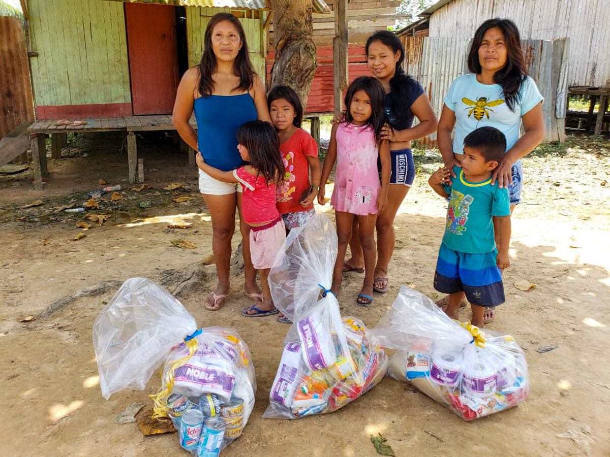 A Mastanahua family receiving donated food and supplies.