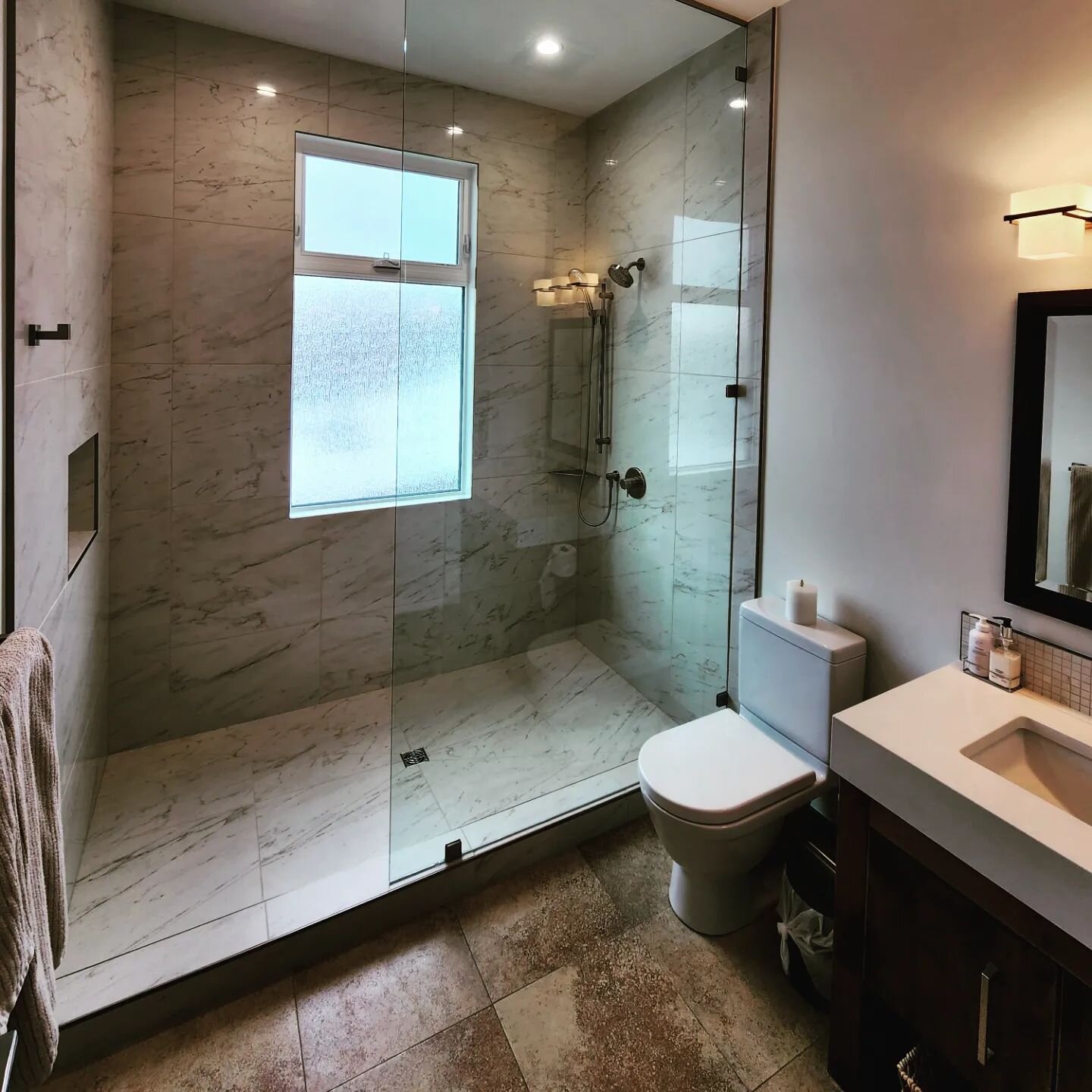 Hey, look! A bathroom reno!

We converted this massive tub only bathroom into an even larger walk-in shower, updated the vanity with a waterfall quartz top, undermount basin, and Riobel lav faucet. 

The existing wood frame window was changed out for