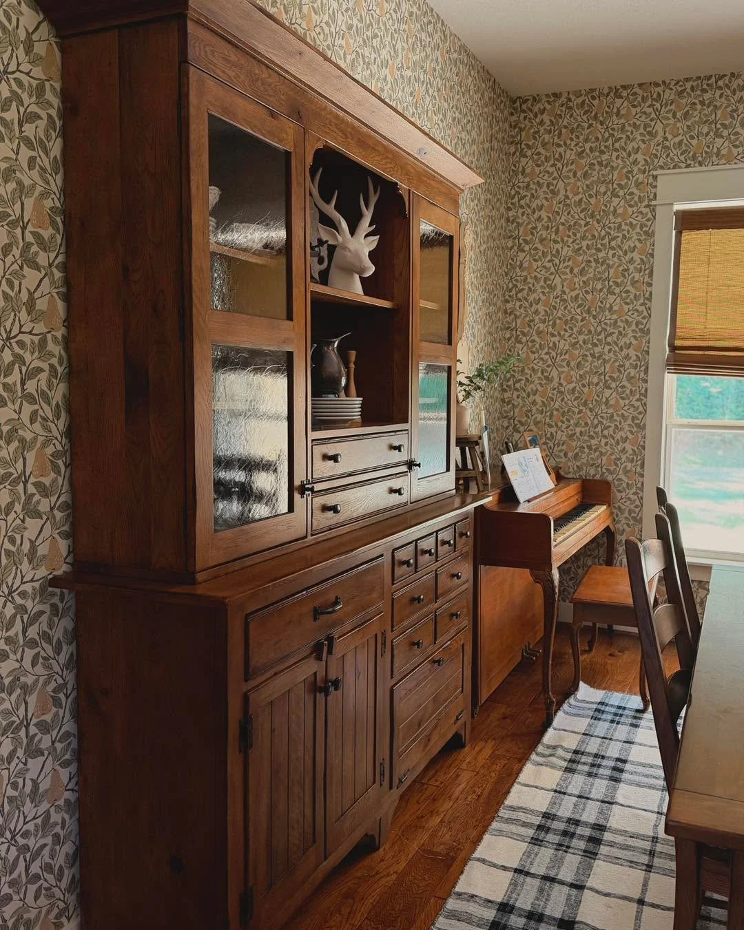 The house is still, the coffee is warm, and for a few minutes, this room belongs only to the morning light. 

This pear-patterned wallpaper feels like a nod to the past&mdash;a bit of European heritage that grounds the room and makes the walls feel l