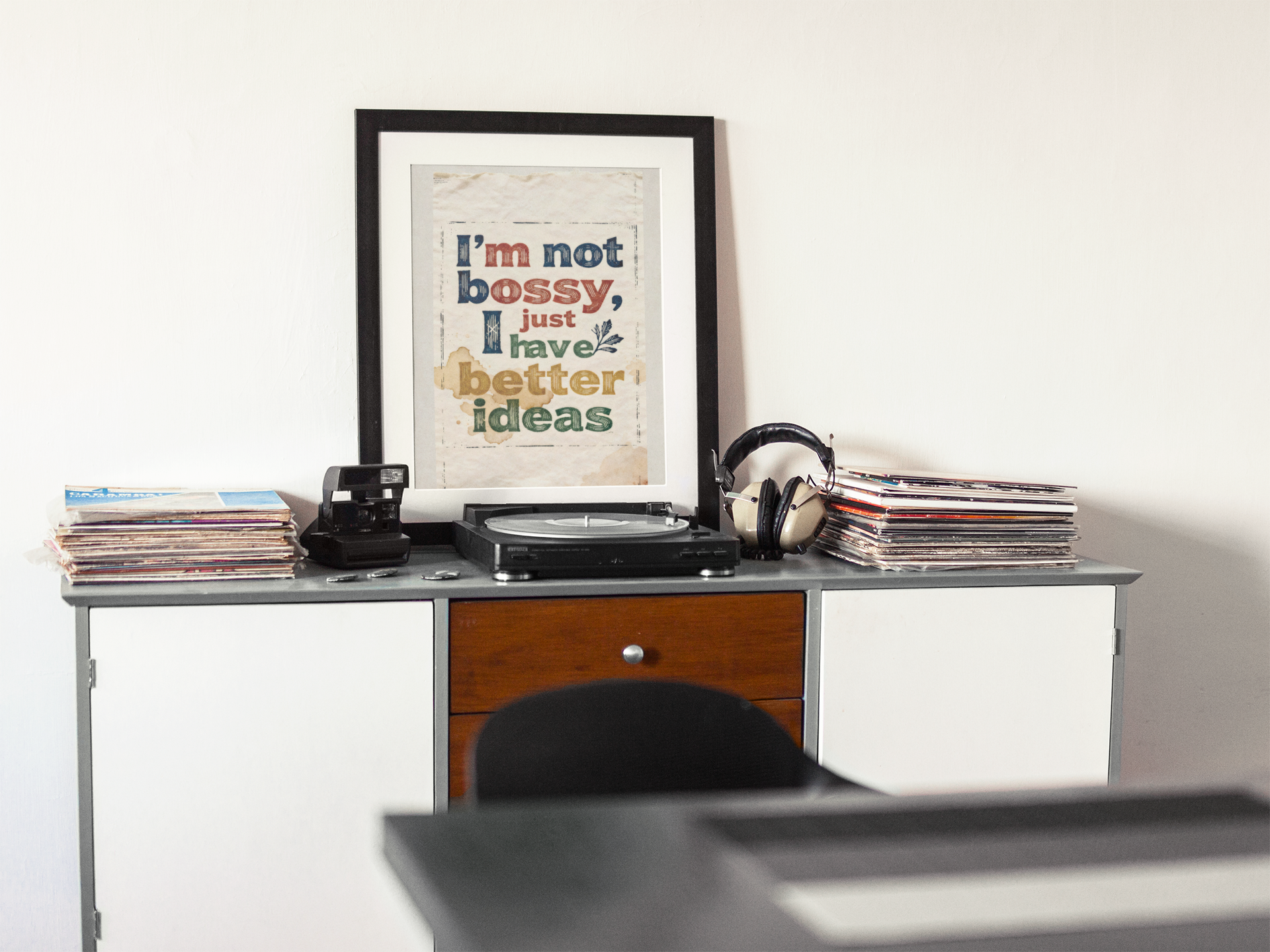 framed-art-print-template-on-a-white-wall-nearby-a-turntable-and-vinyls-a14671.png