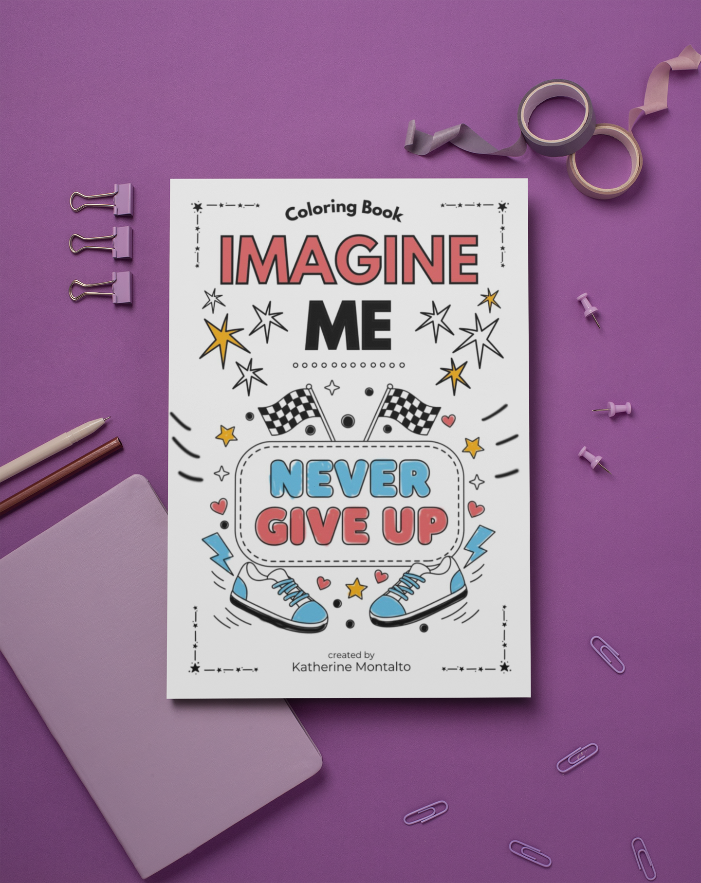 Coloring book titled 'Imagine Me - Never Give Up' placed on purple background, surrounded by pencils, paper clips, washi tapes, push pins, and a lilac notebook.