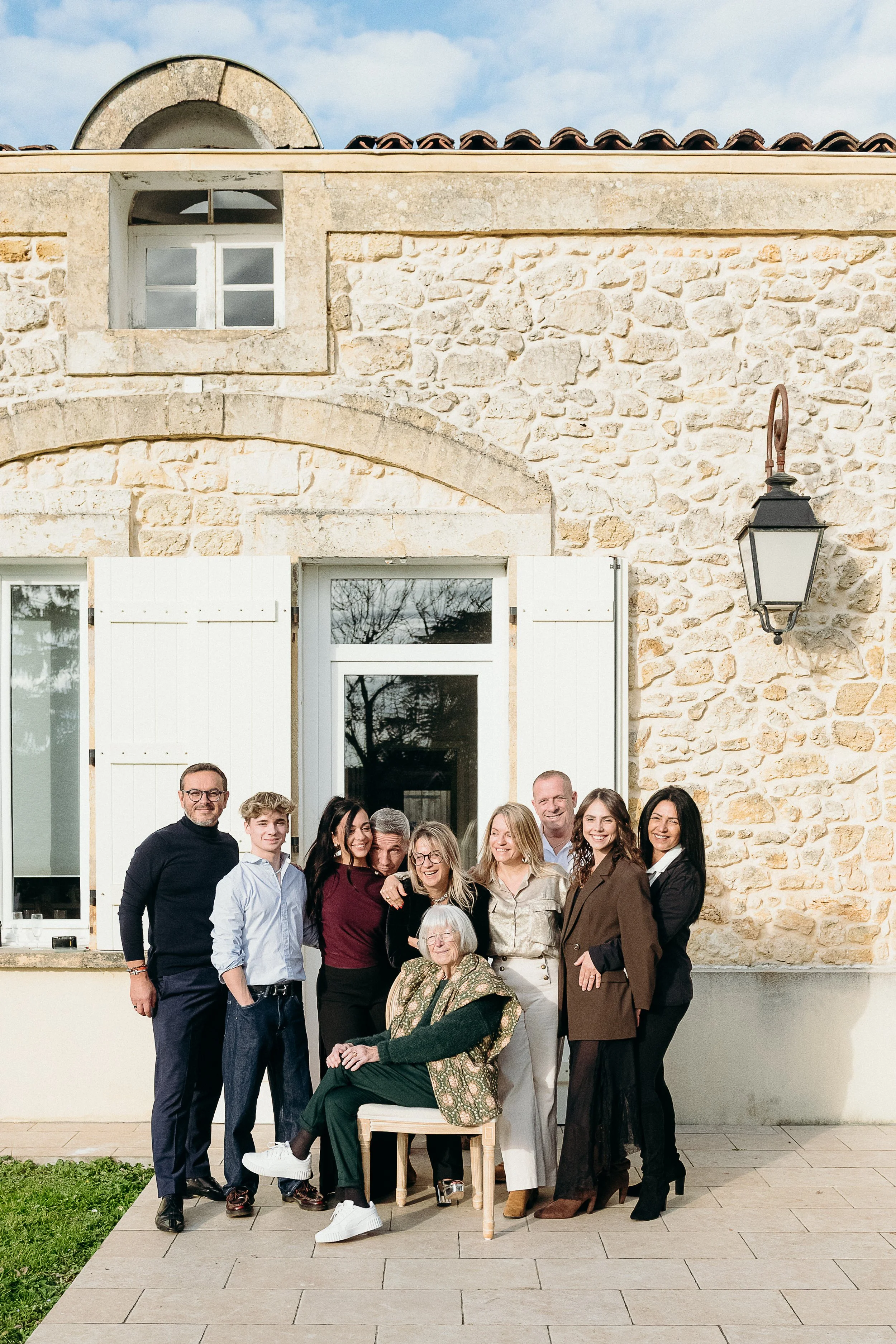 Séance photo famille à Bordeaux avec plusieurs générations réunies devant la maison de famille