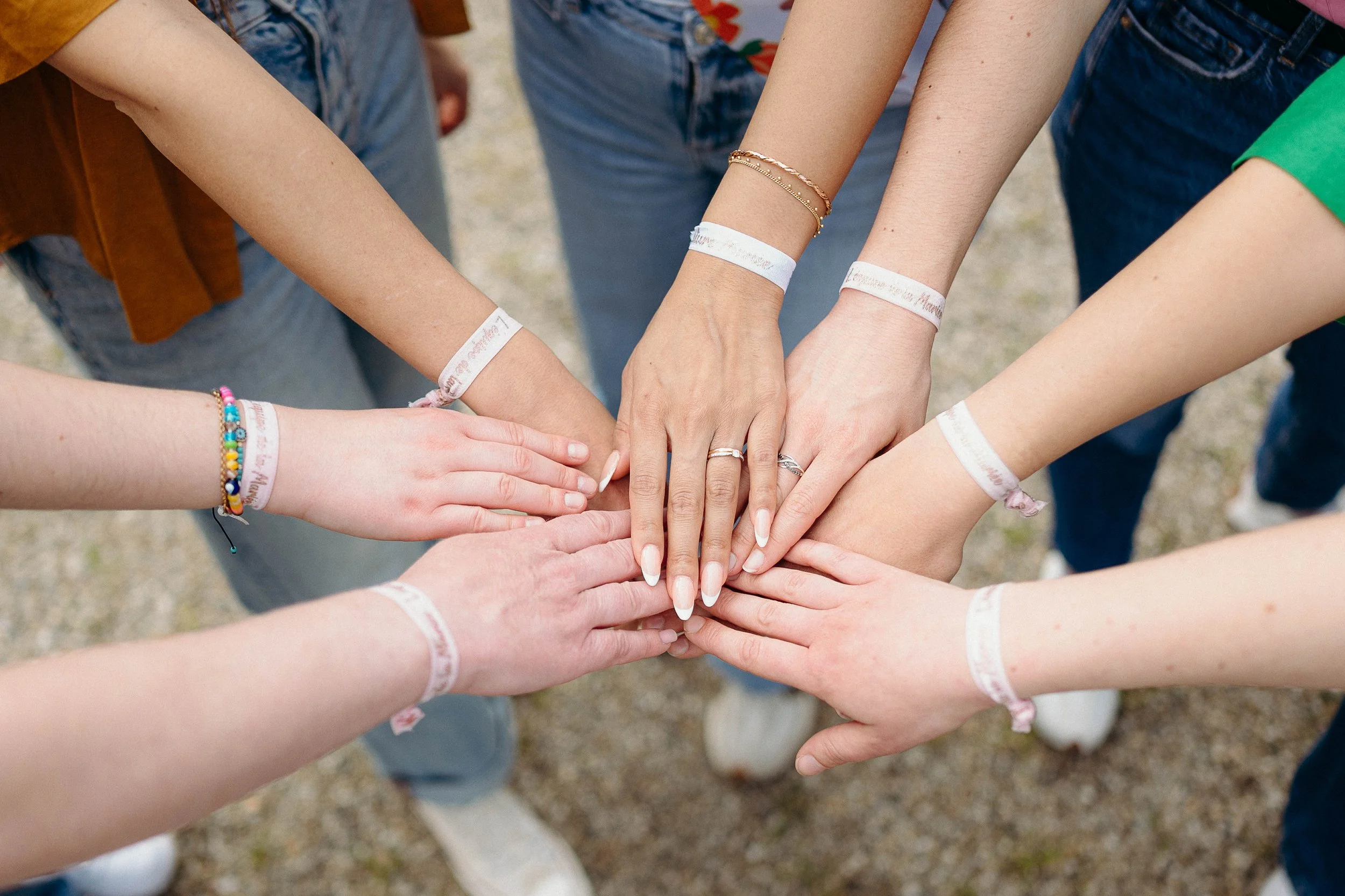 Détail des mains réunies lors d’un enterrement de vie de jeune fille à Bordeaux, symbole de complicité