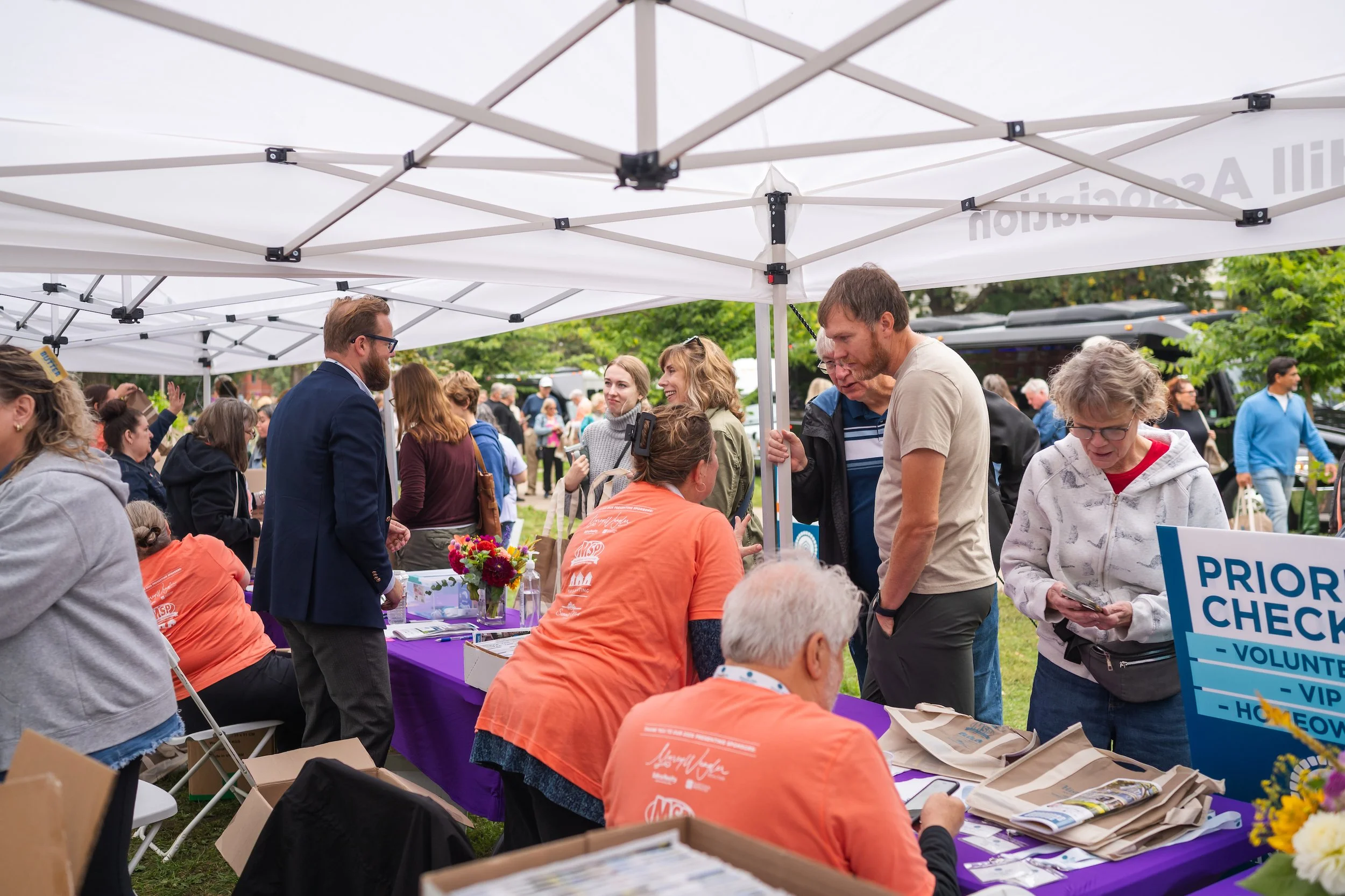 Volunteers checking attendees in at a table.