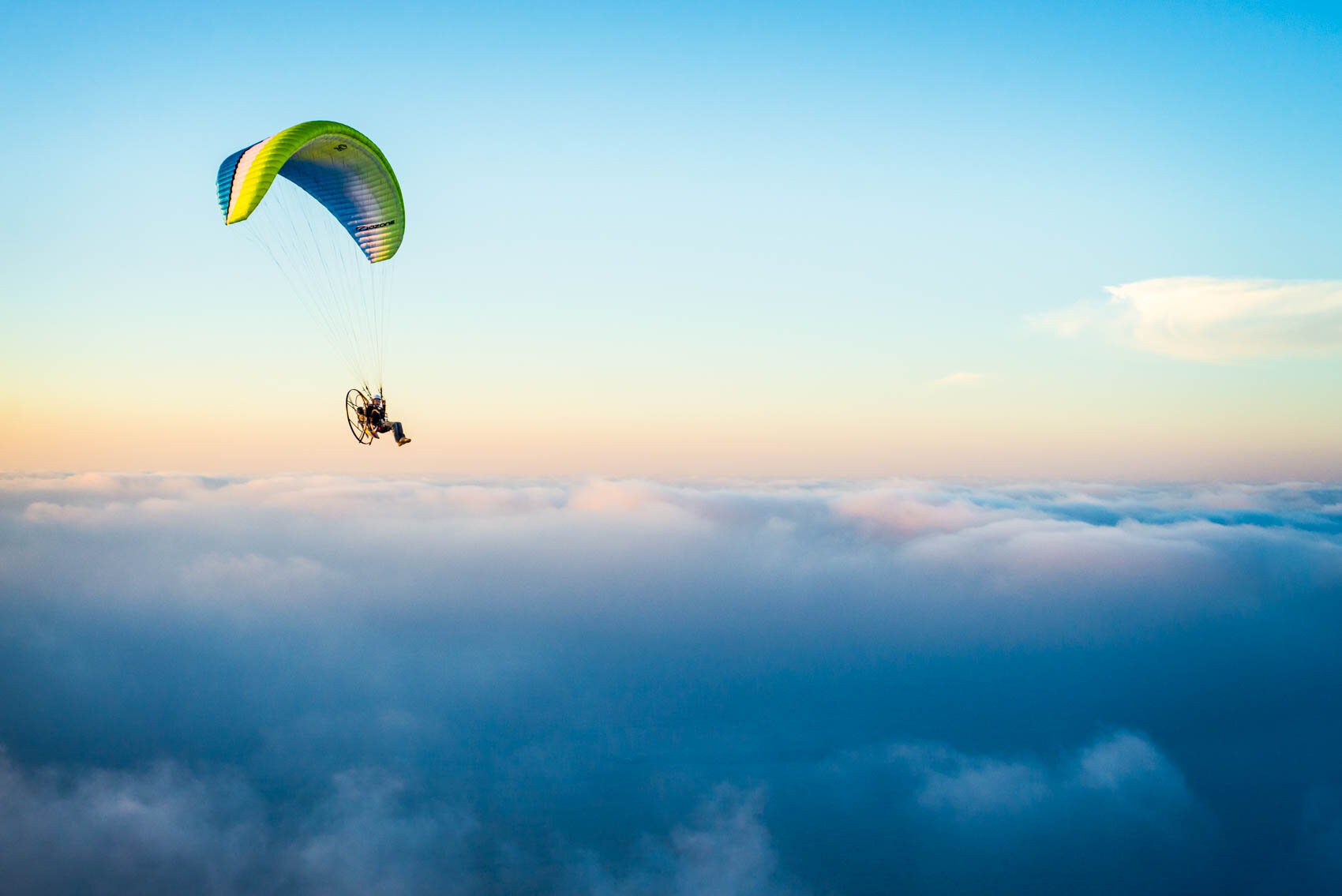stock-photo-a-paramotor-pilot-at-sunrise-climbing-through-early-morning-clouds-over-the-arabian-desert-246733909.jpg
