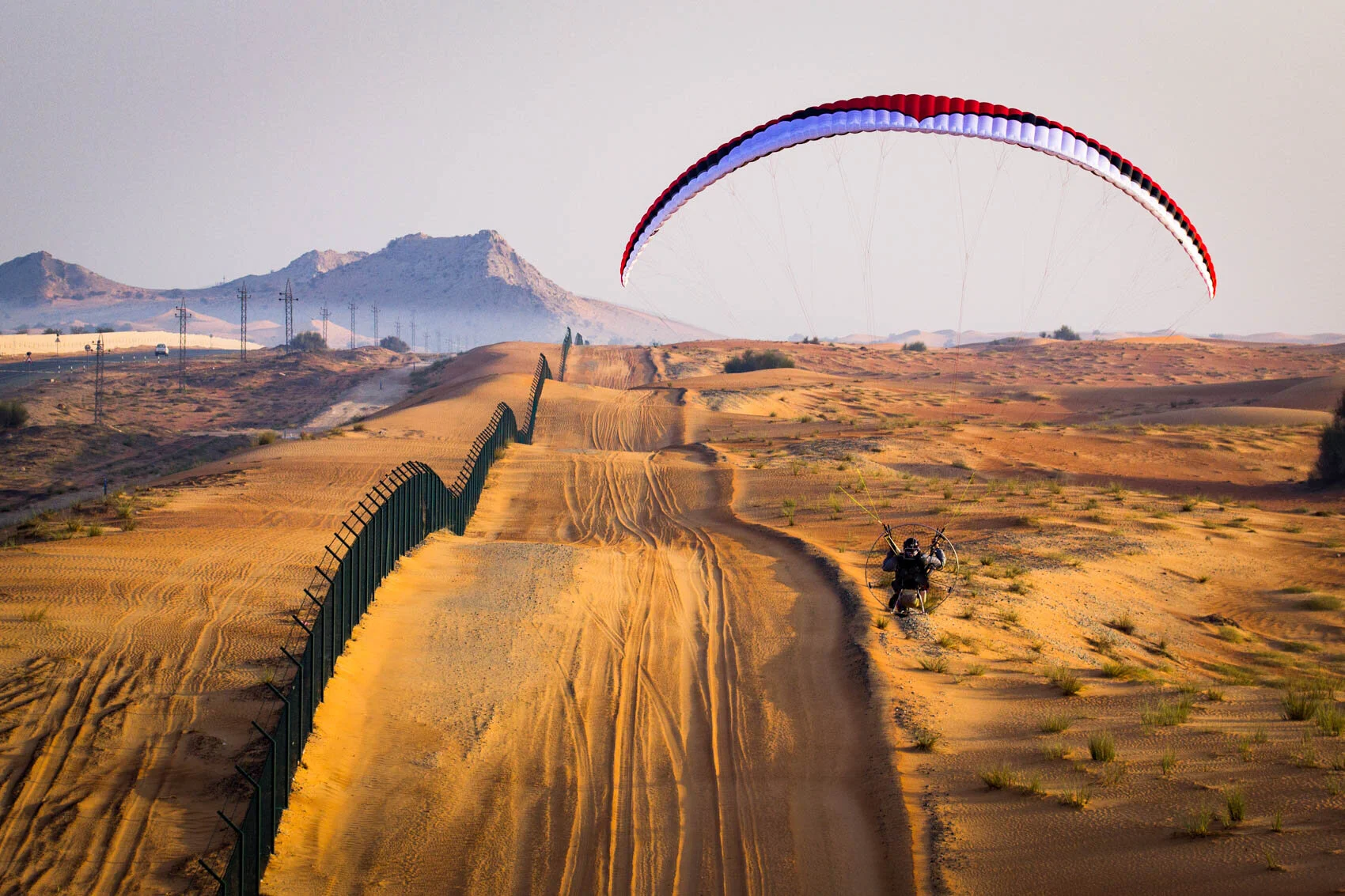 stock-photo-a-paramotor-explores-the-sand-dunes-and-arabian-desert-from-the-sky-246733949.jpg