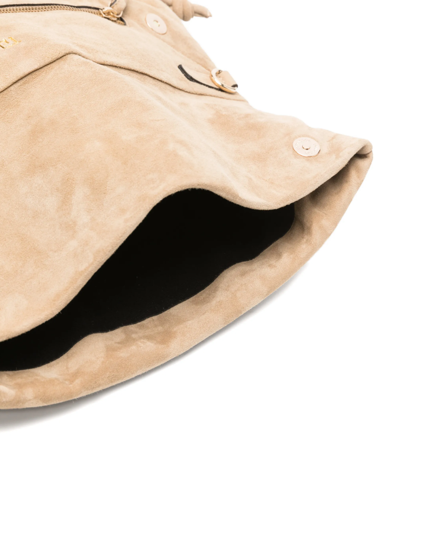 Tela beige leather clutch with flap, gold-tone hardware, shoulder strap, and zip closure.