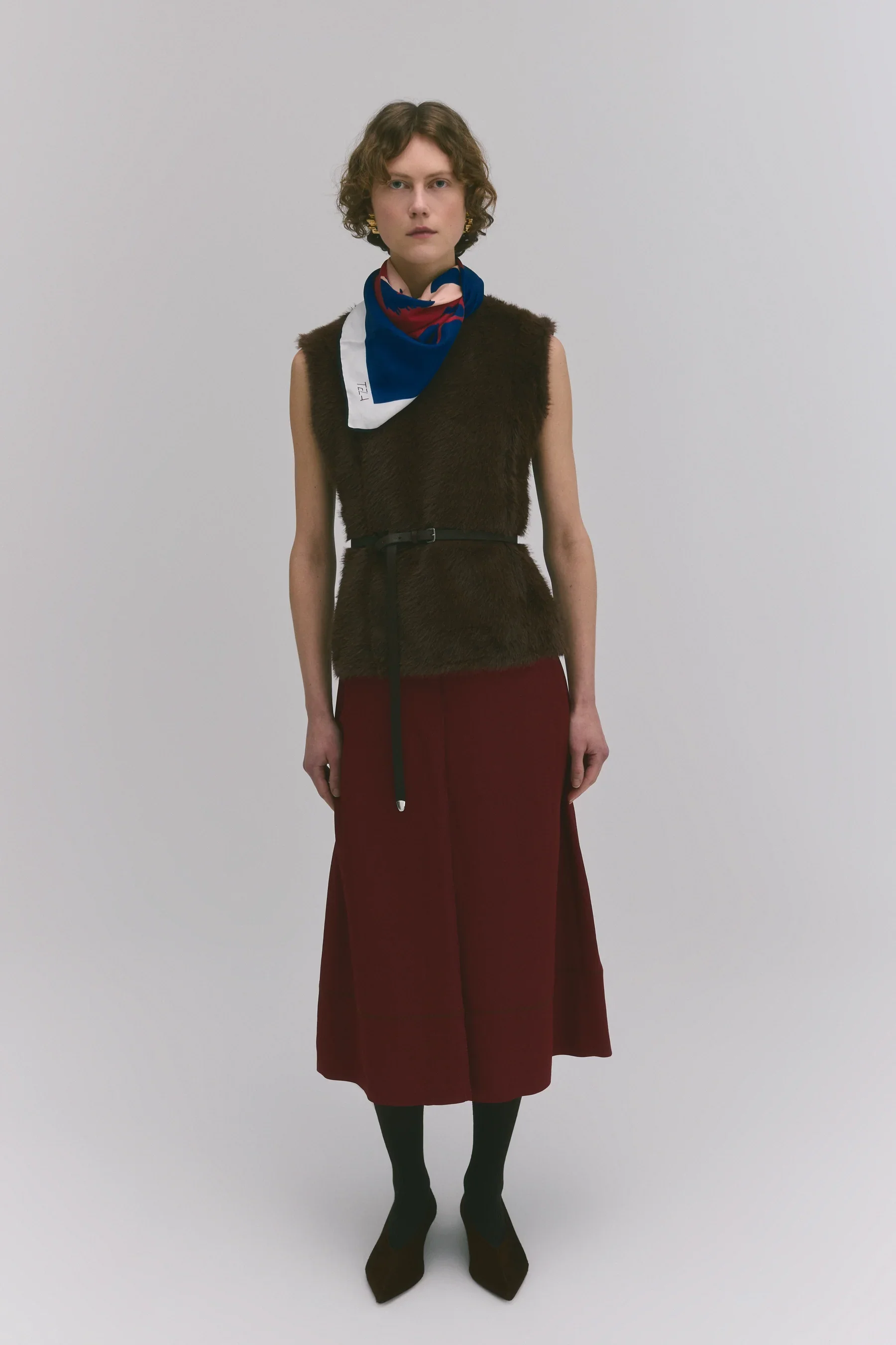 TELA Wool-Blend Satin Midi Skirt in Cherry Red, featuring soft pleats, fluid movement and distinctive contrast stitching.